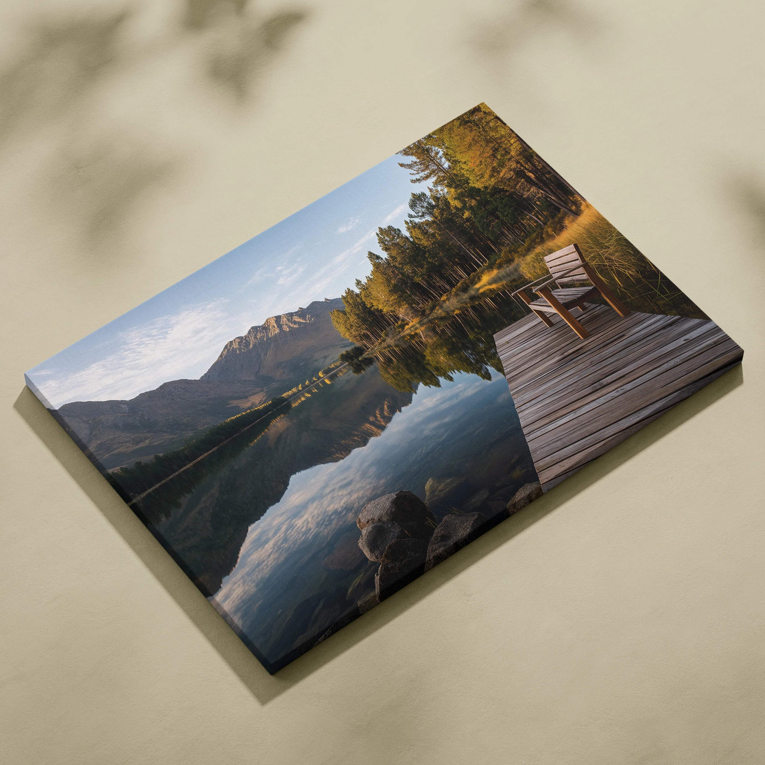 Serene lakeside dock by glassy lake with autumn mountains canvas print