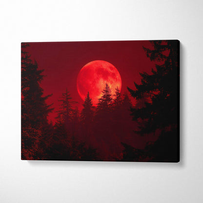 Blood red moon rising over silhouetted pine trees canvas art