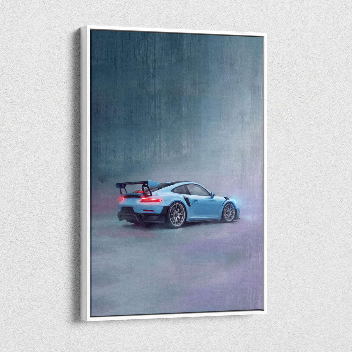 A framed canvas print of a light blue porsche 911 gt3 rs with black racing stripes in motion on a misty gray backdrop
