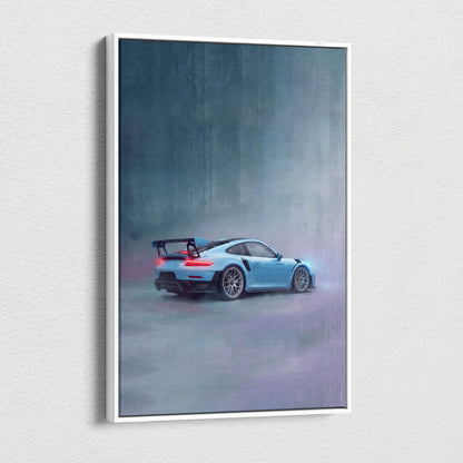 A framed canvas print of a light blue porsche 911 gt3 rs with black racing stripes in motion on a misty gray backdrop