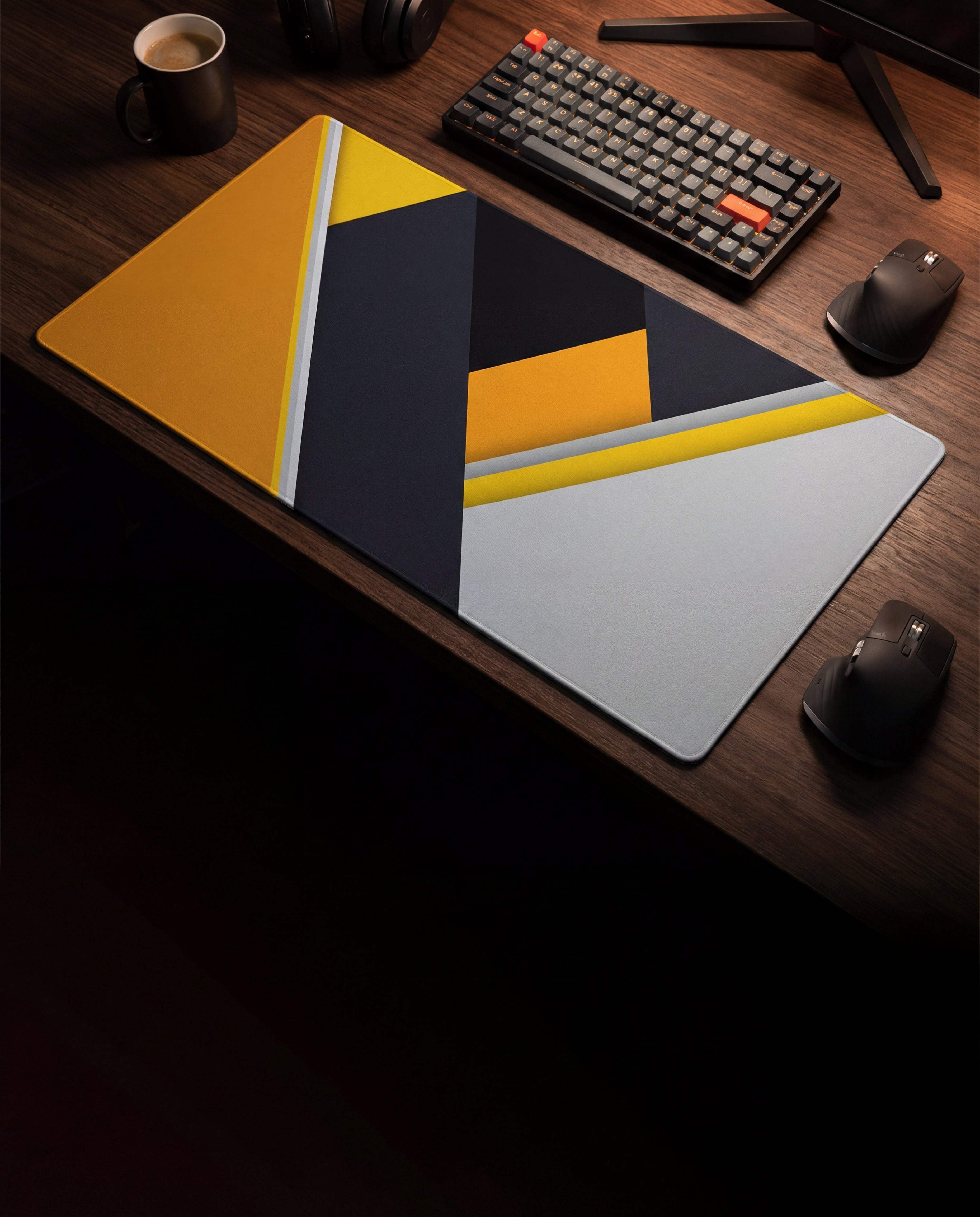 A sleek, geometrically designed mousepad with bold yellow and dark gray panels accented by white lines.