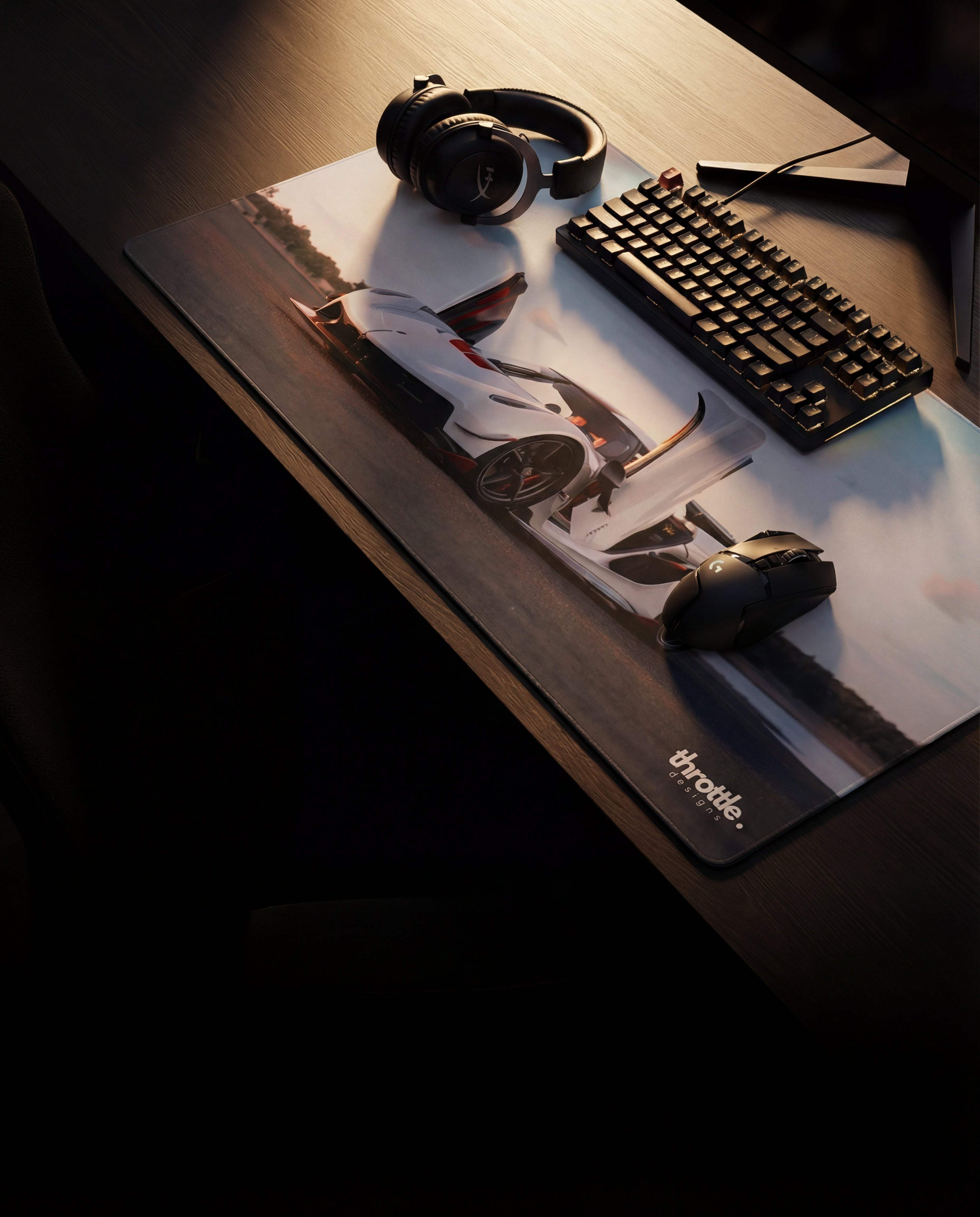 A sleek, rectangular gaming mousepad featuring a high-resolution print of a white sports car on a racetrack with the ’throttle’ brand logo in the corner.