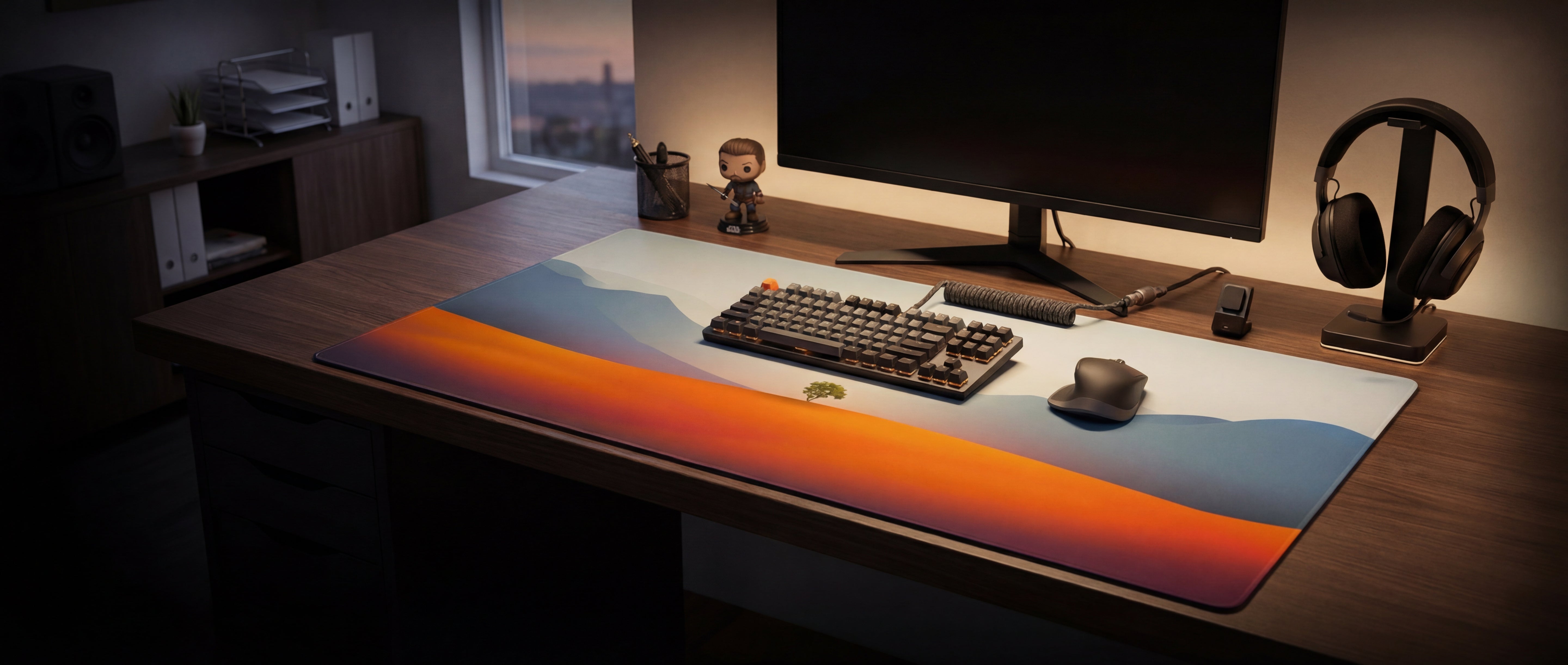 A sleek, rectangular gaming mousepad featuring a vibrant sunset landscape design with orange and blue gradients.