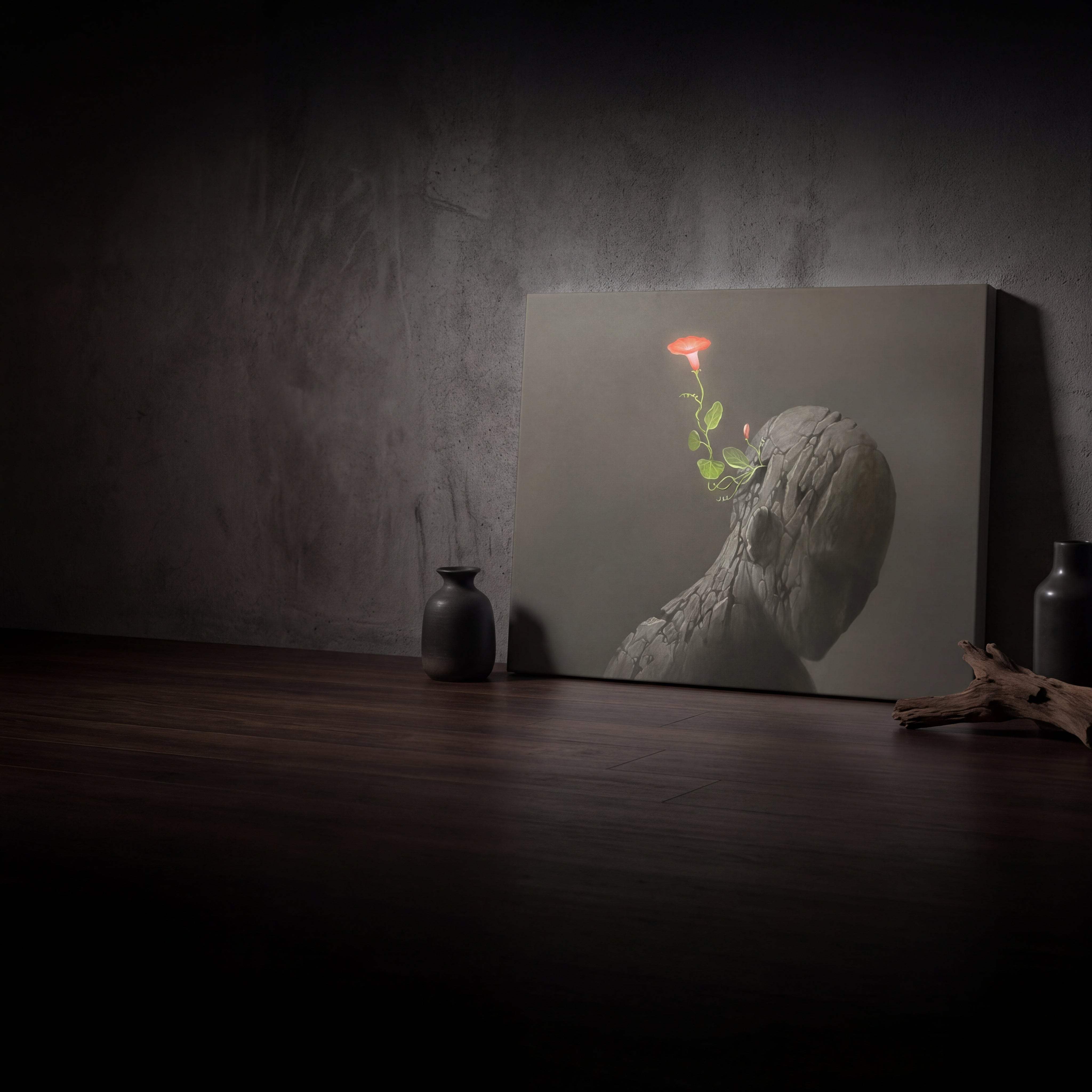 A canvas print featuring a textured, grayish stone-like figure with a glowing orange flower emerging from its head.