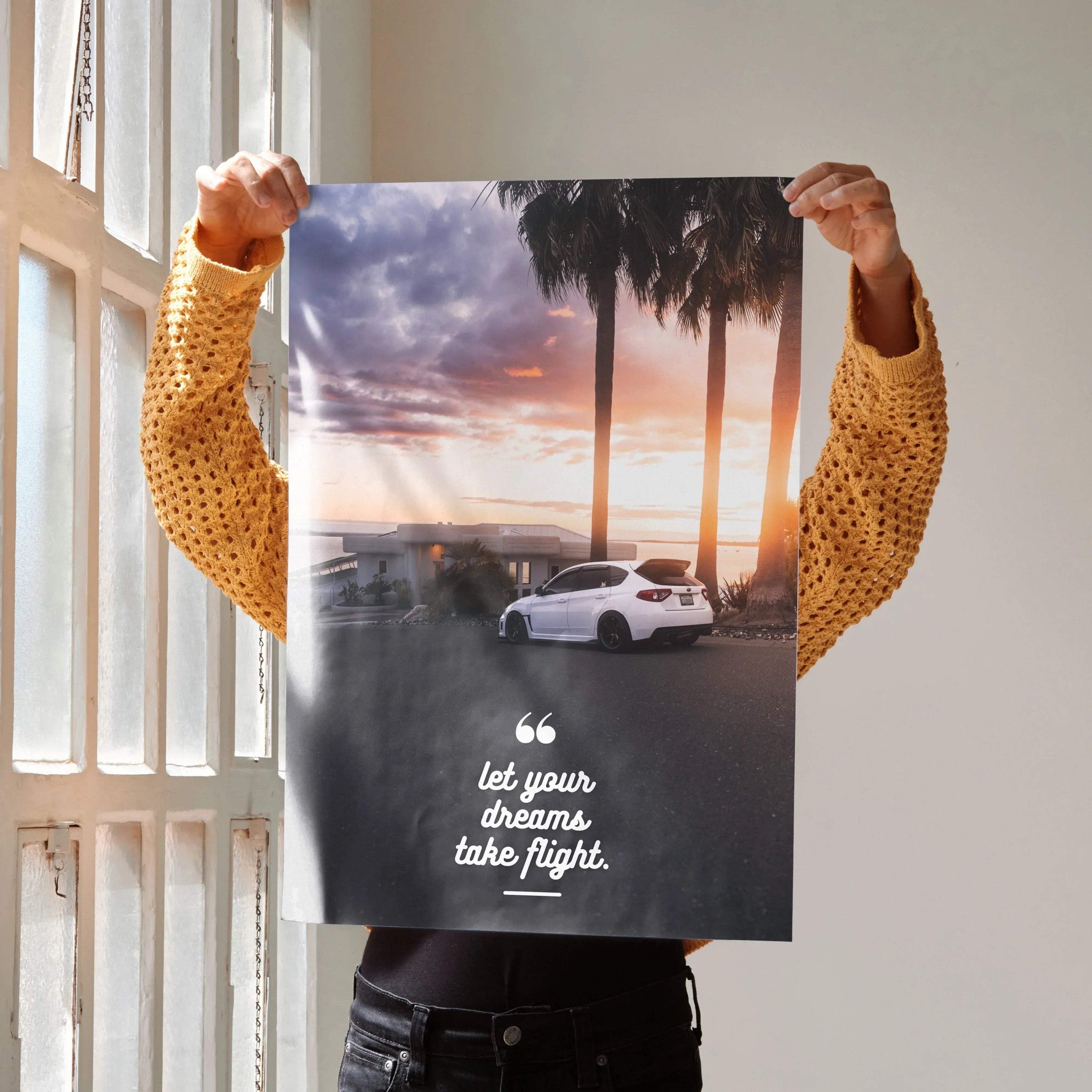 Motivational poster wall art featuring a white Subaru WRX STI at sunset with inspiring text.