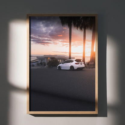 Subaru WRX STI parked with sunset sky and palm trees poster wall art in wooden frame.