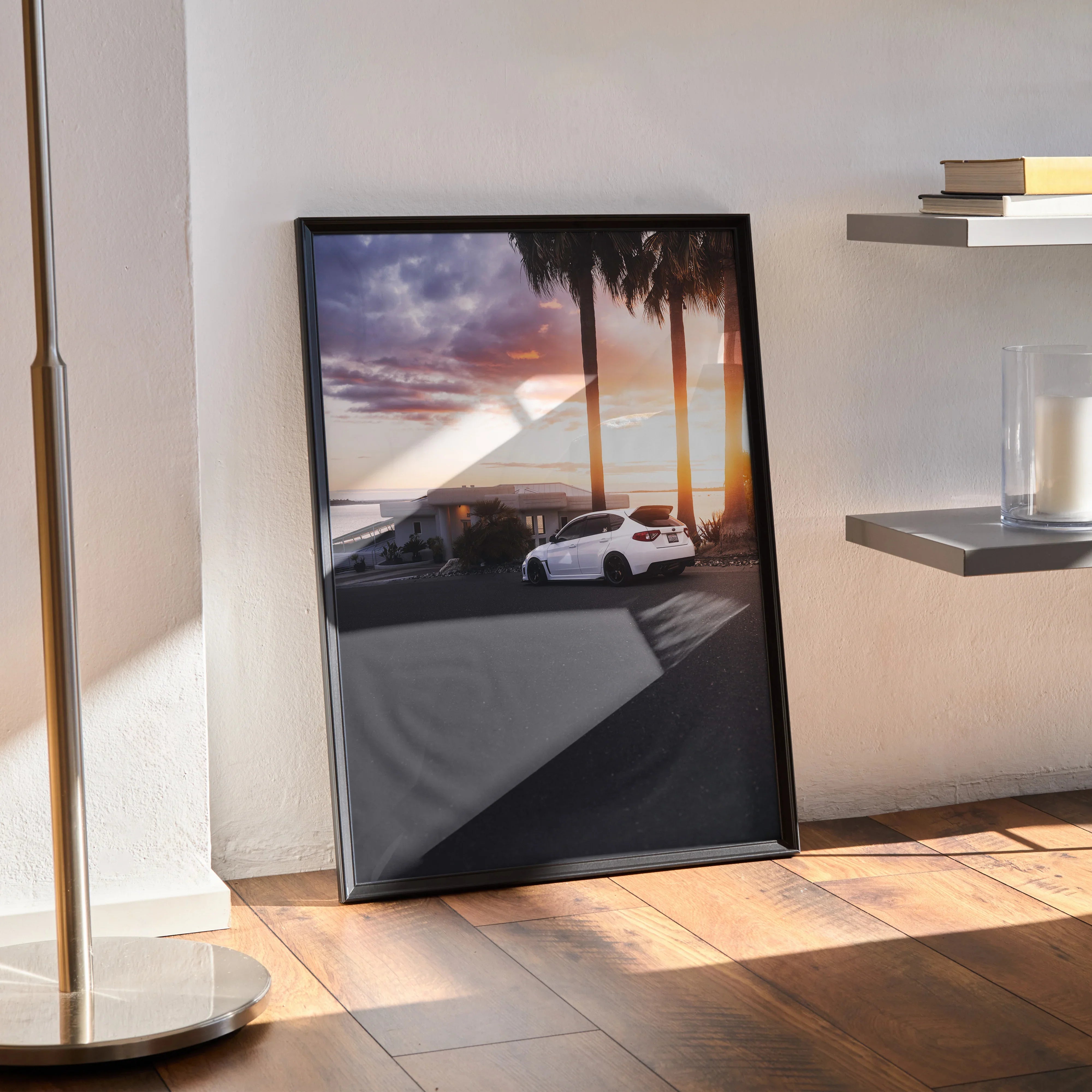 Subaru WRX STI parked at sunset with palm trees poster wall art in black frame.