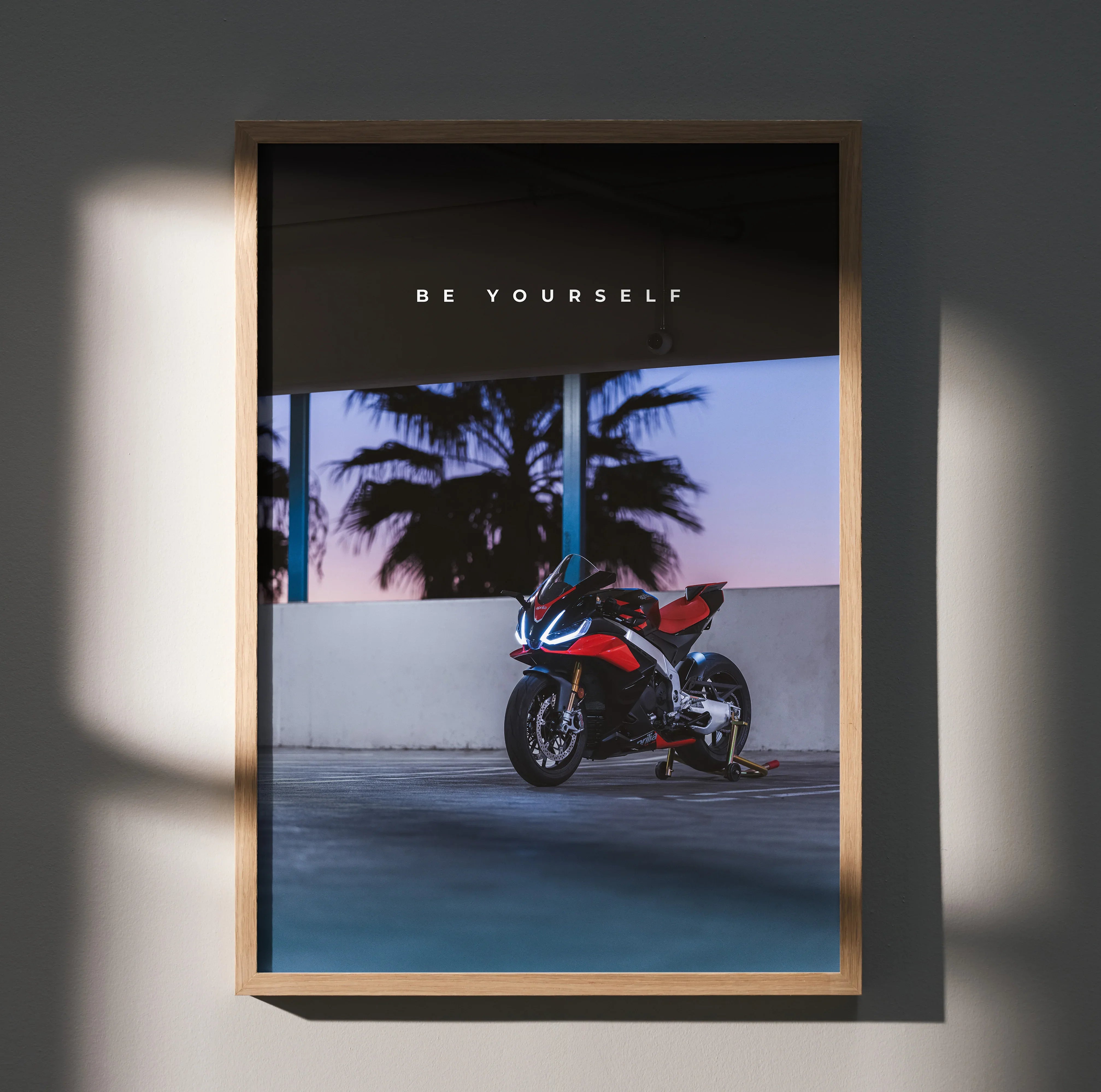 Motivational poster wall art featuring Aprilia RSV4 1100 Factory #005 motorcycle with sunset and palm trees background.