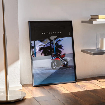 Aprilia RSV4 1100 Factory motorcycle poster wall art with palm trees and sunset background in black frame.