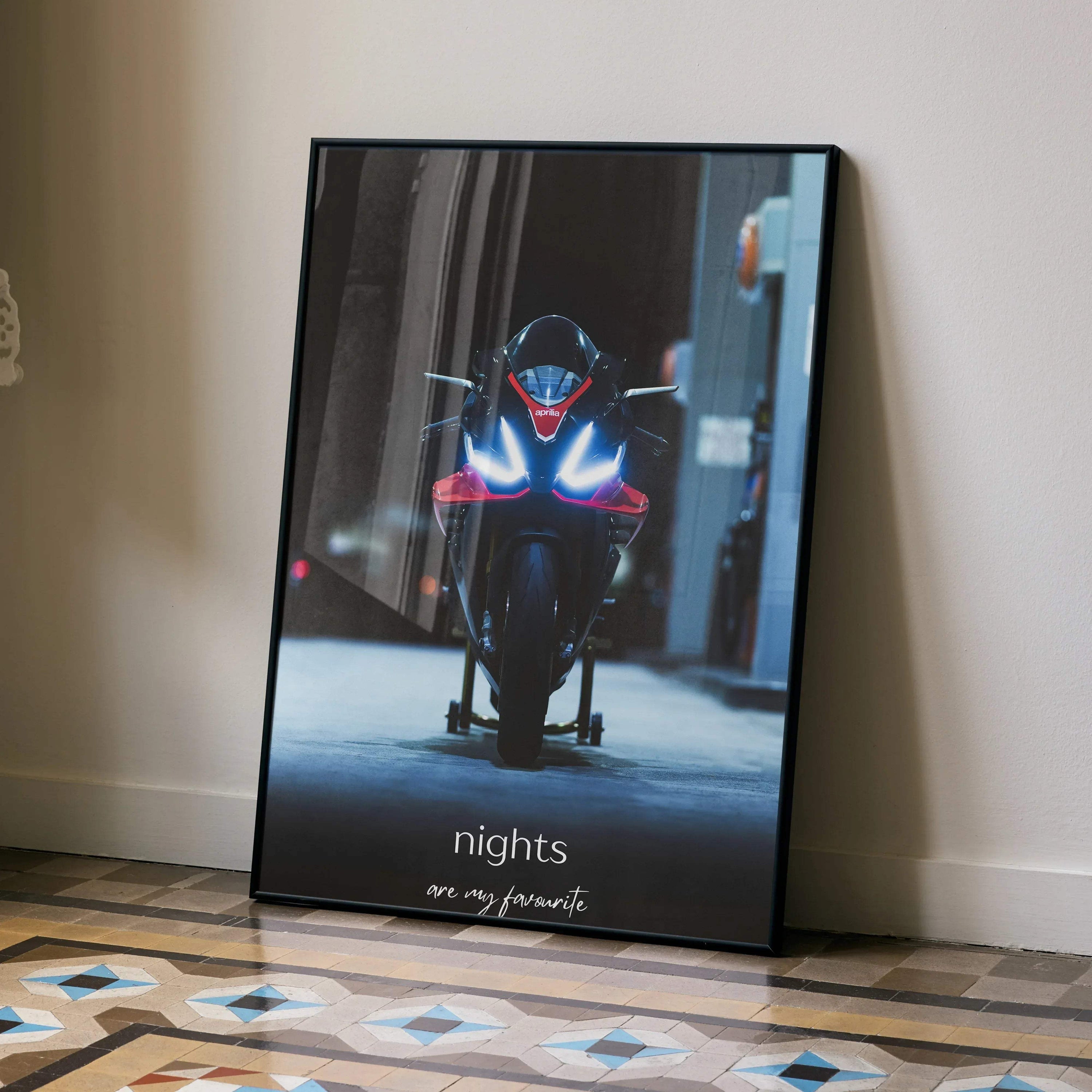 Aprilia RSV4 1100 Factory motorcycle lit at night poster wall art in black frame.