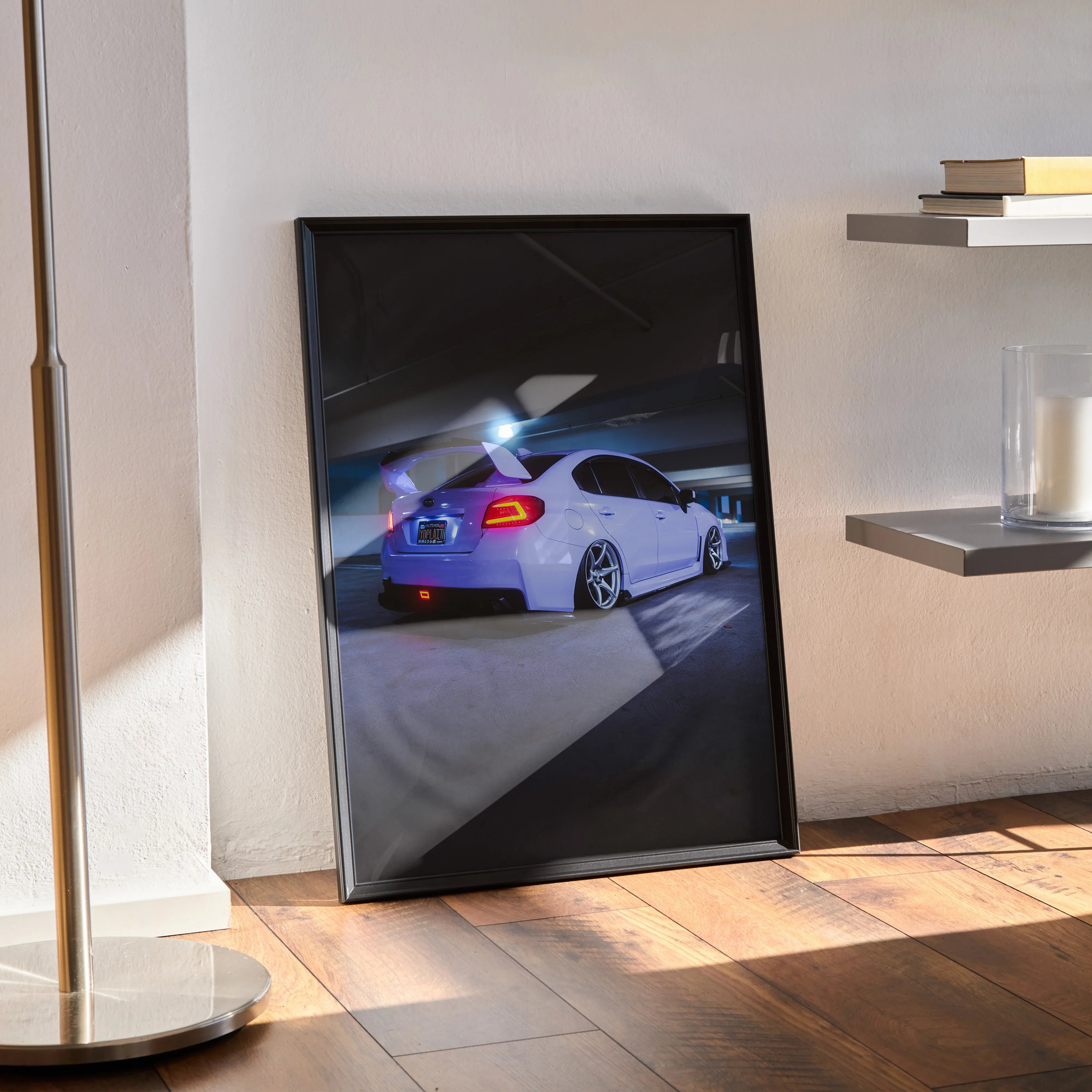 Subaru WRX white sports car poster in black frame leaning on wall, automotive wall art.