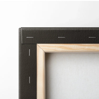 Close-up of stretched canvas art with wooden frame and black folded edges for wall art display.