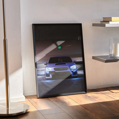 Framed Subaru WRX poster with illuminated headlights in dark setting, modern wall art display.