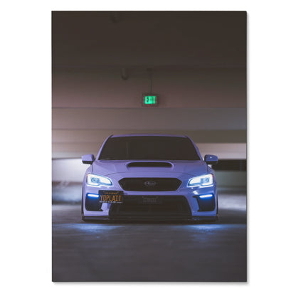 Subaru WRX front view with illuminated headlights poster wall art in dark garage setting.