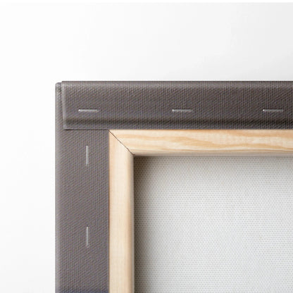 Close-up of wooden framed canvas corner with gray fabric backing and stapled edges for wall art canvas print.