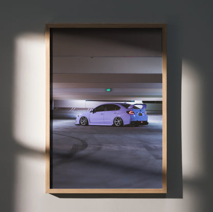 Subaru WRX parked in dimly lit garage Poster Wall Art in natural wood frame.