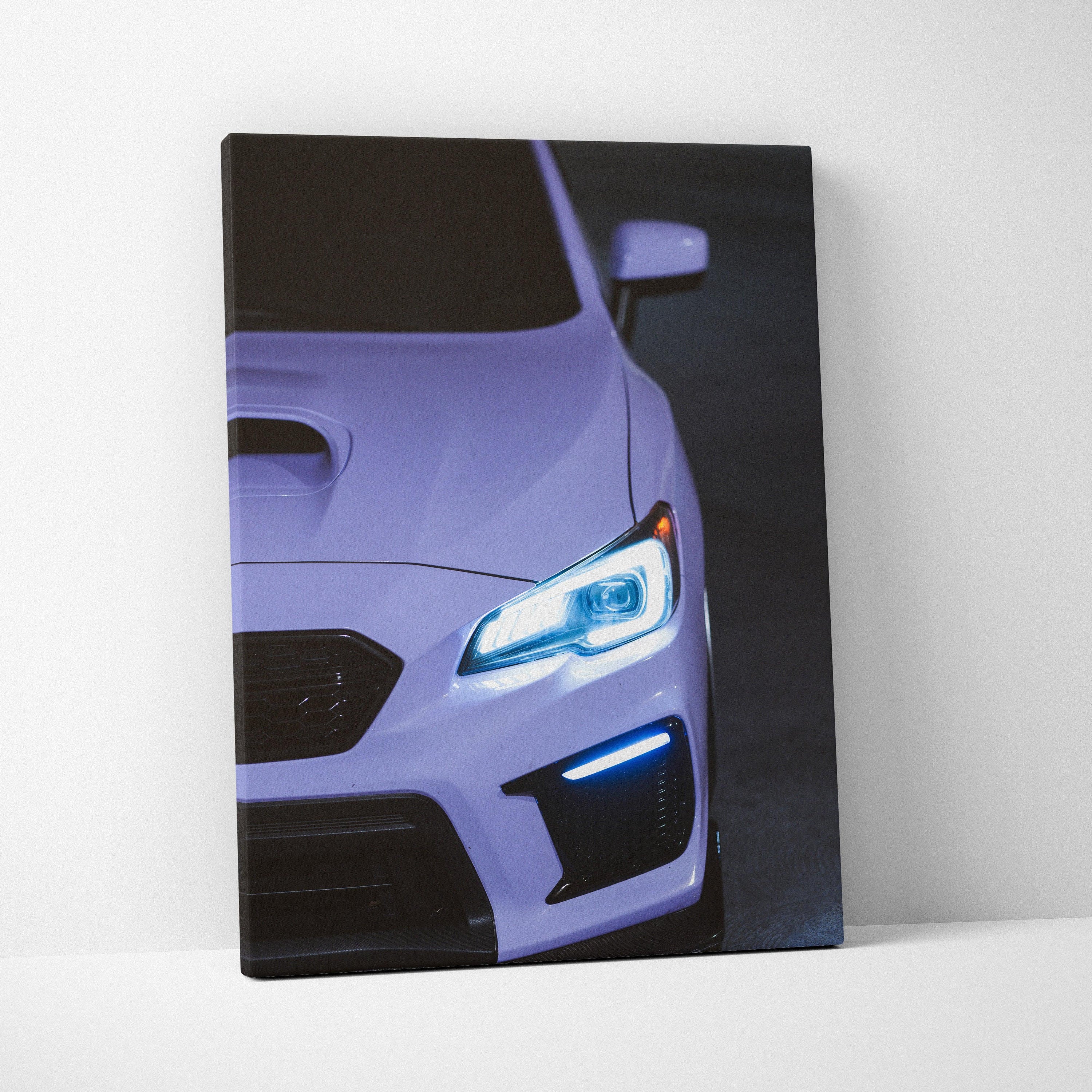Subaru WRX close-up front view with illuminated headlights on vertical canvas wall art.