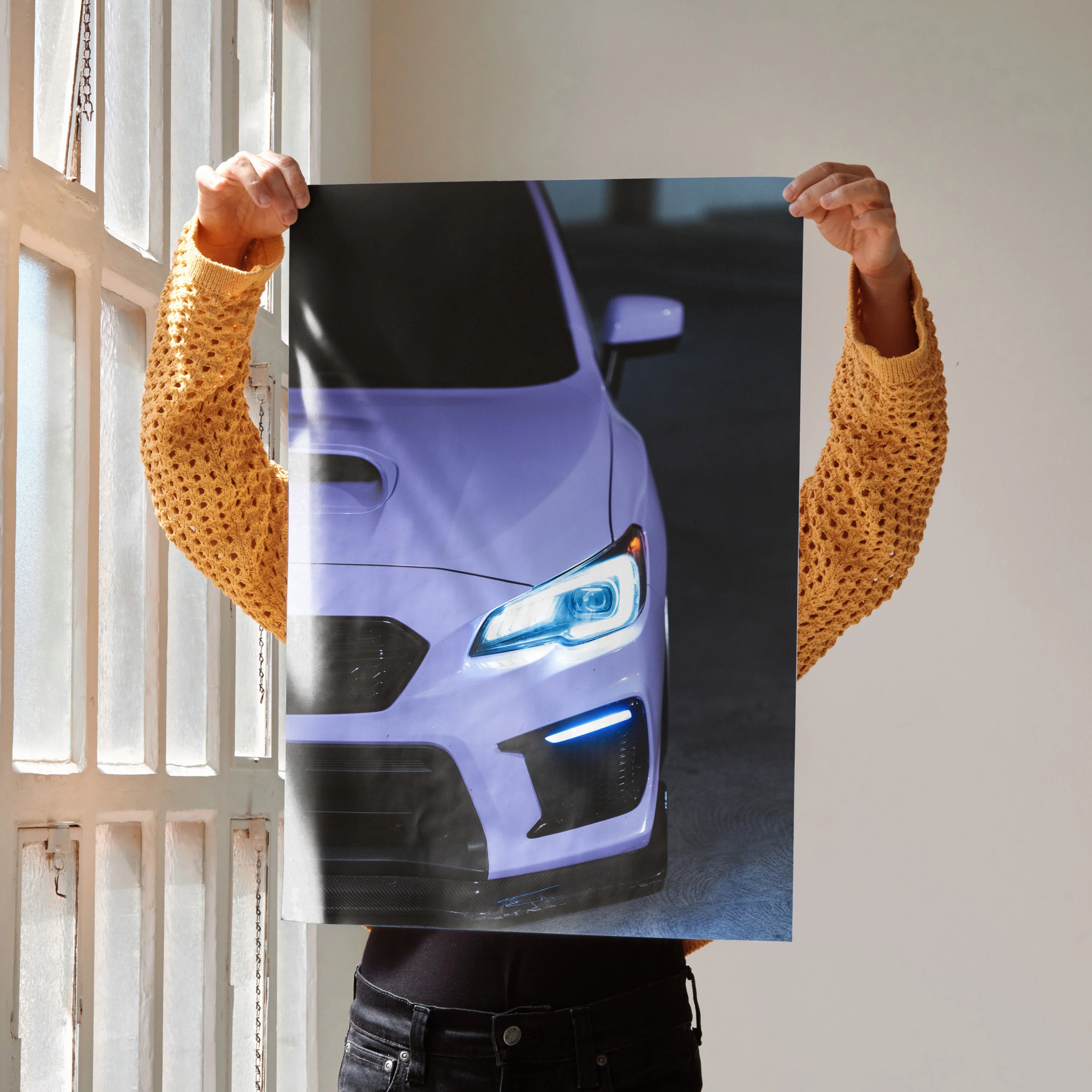 Subaru WRX front view poster wall art with illuminated headlights in dark setting.