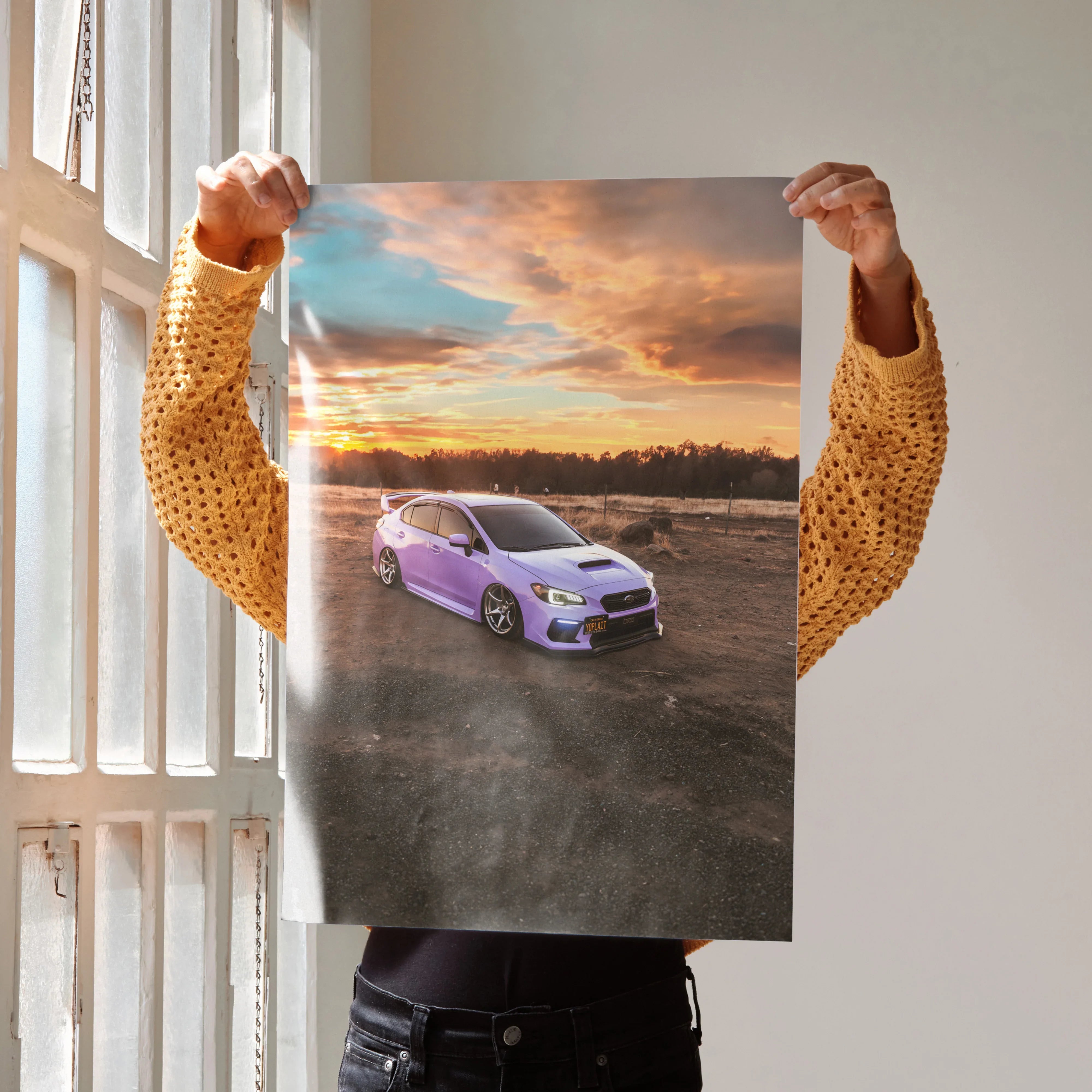 Subaru WRX purple car sunset poster wall art held by person in mustard sweater.