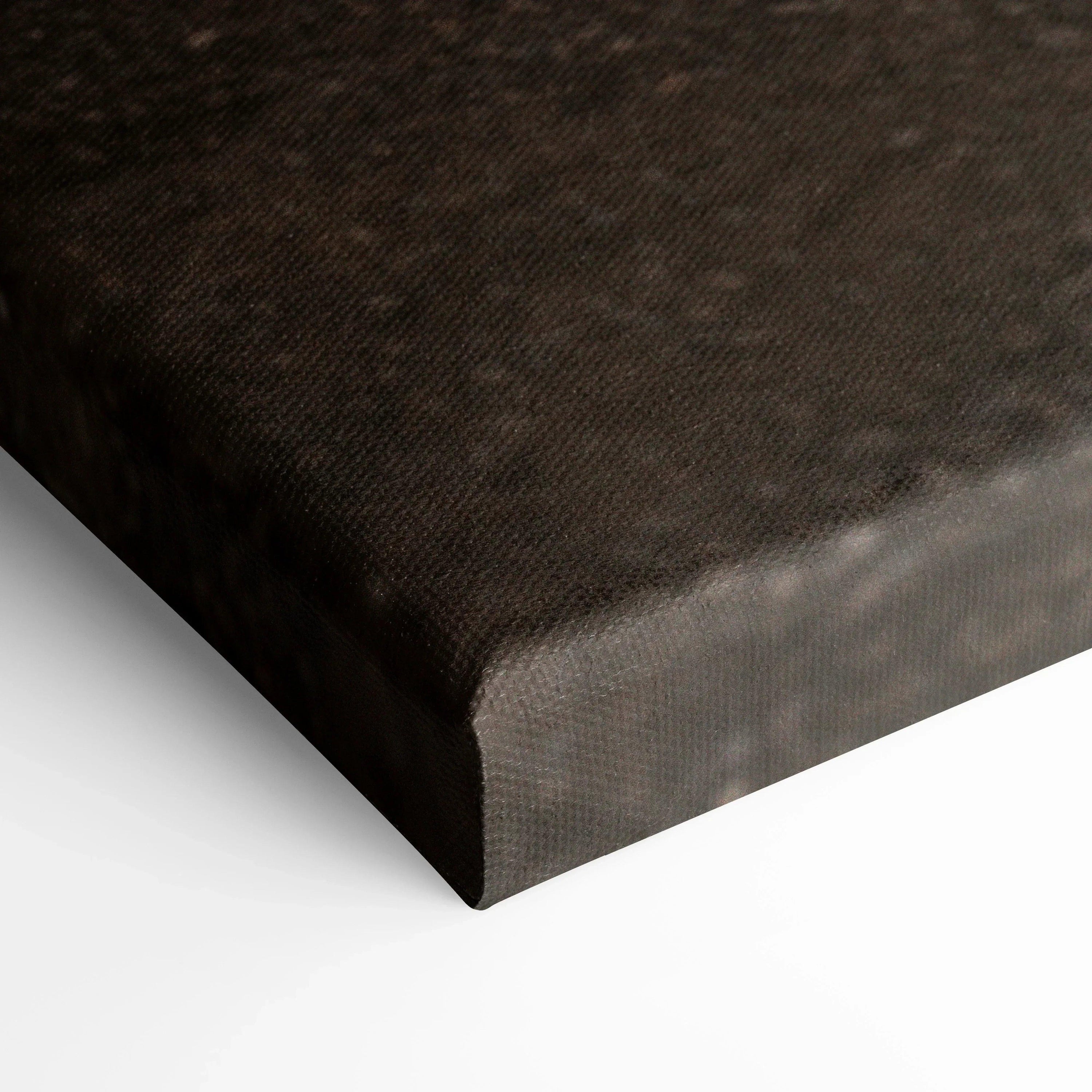 Corner close-up of black textured canvas wall art with museum-quality print and wrapped edges.