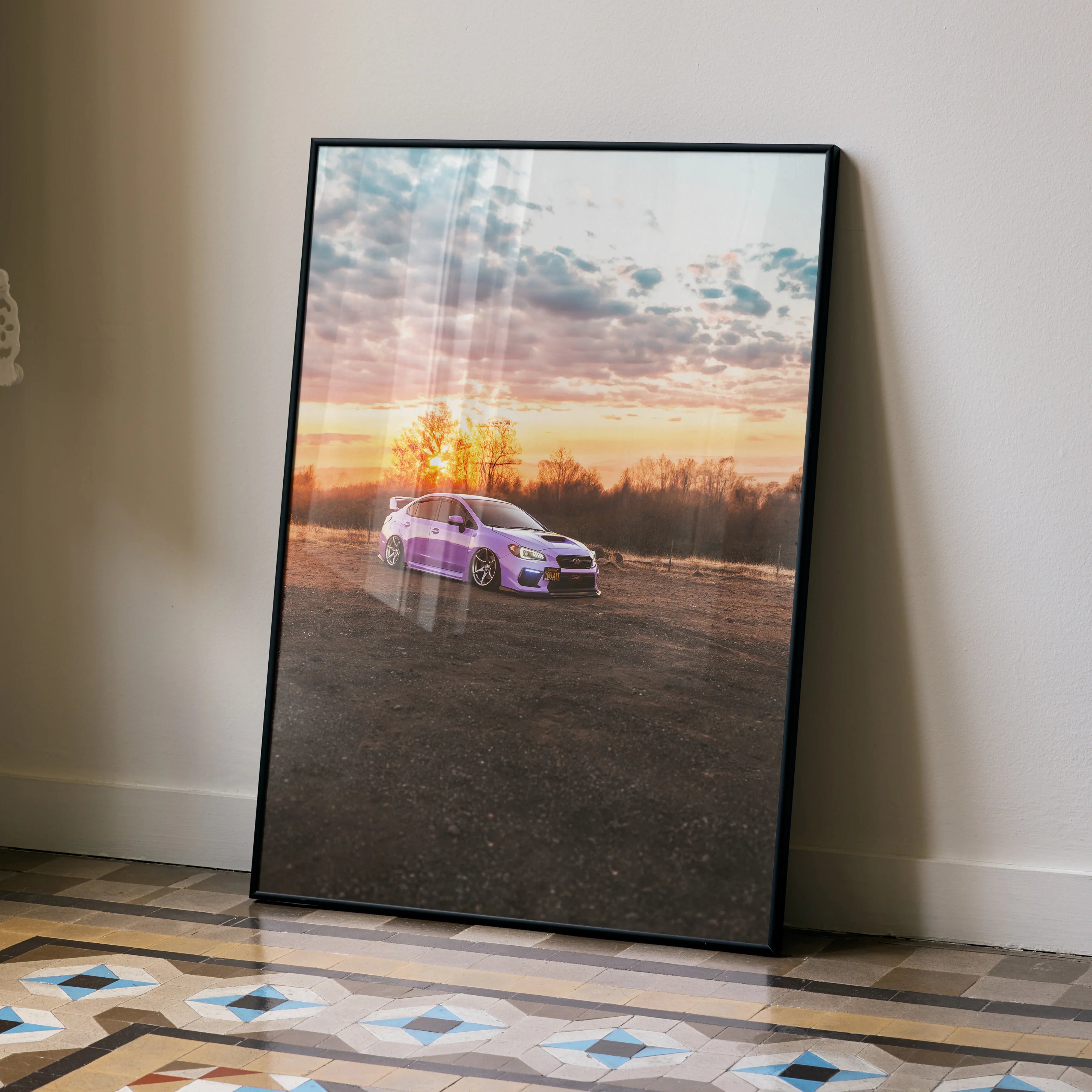 Subaru WRX parked at sunset with vibrant sky poster wall art in black frame.
