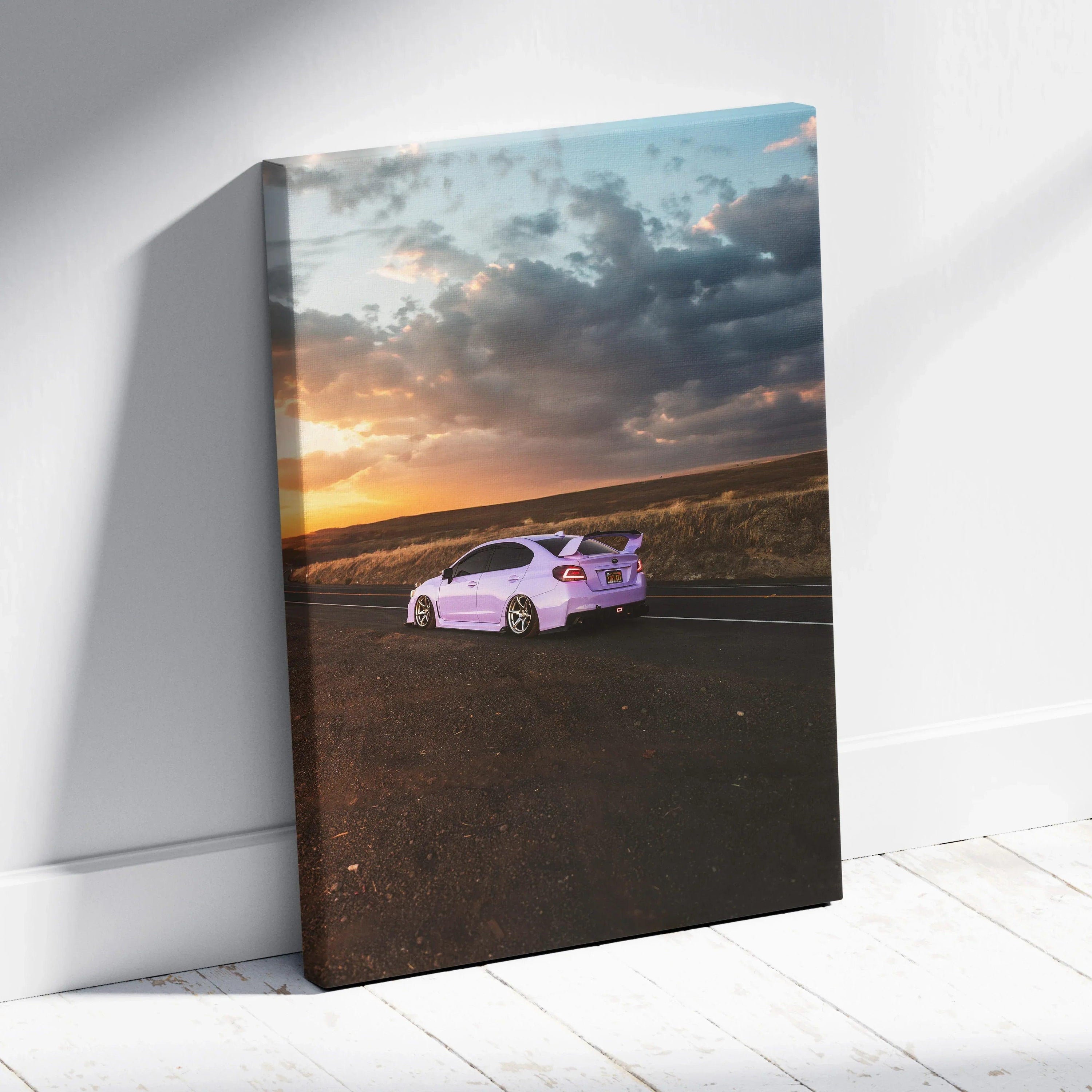White Subaru WRX on open road at sunset with dramatic sky, vertical canvas wall art.