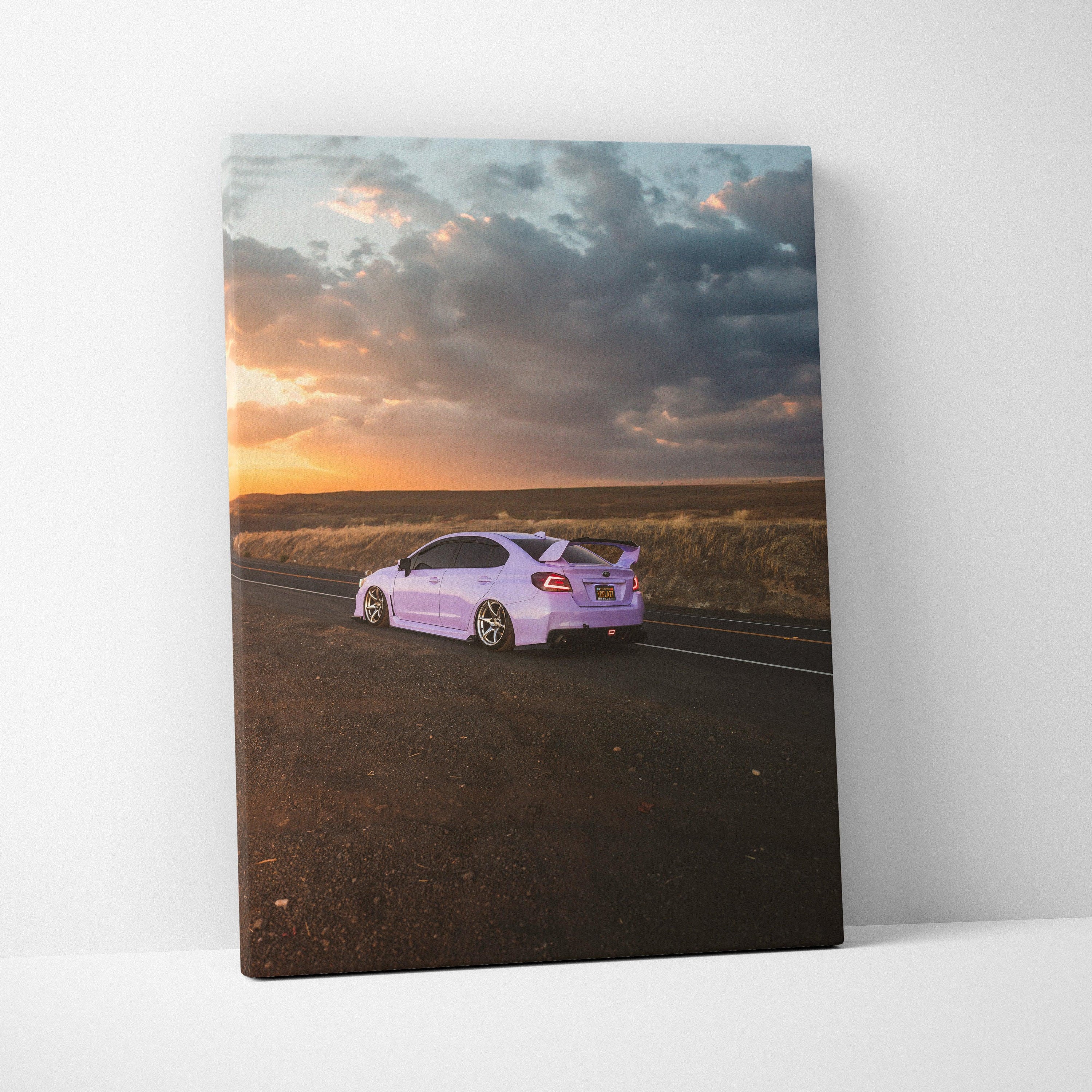 Subaru WRX in lavender on road at sunset with dramatic clouds canvas wall art.