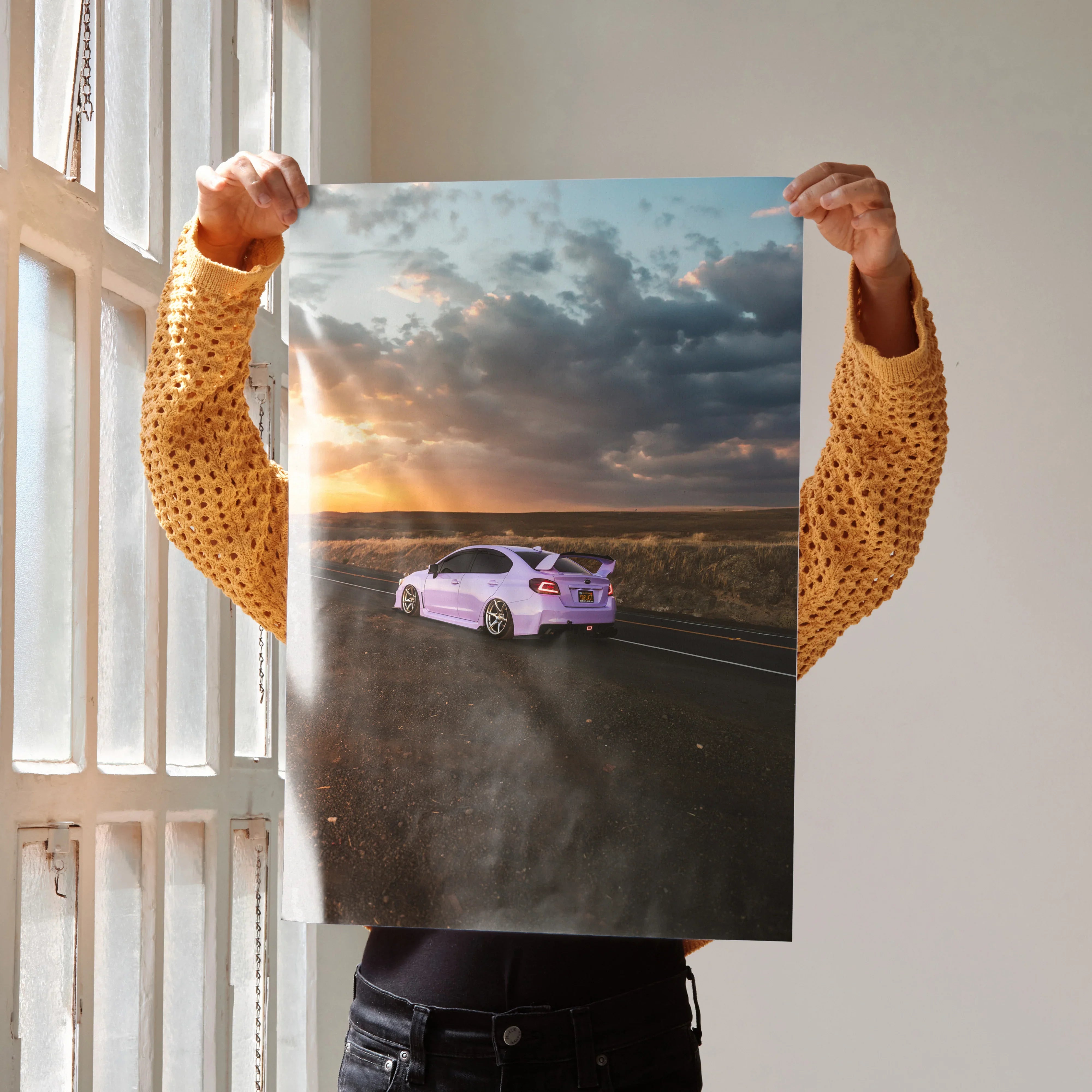 Subaru WRX driving on open road at sunset with dramatic clouds poster wall art.