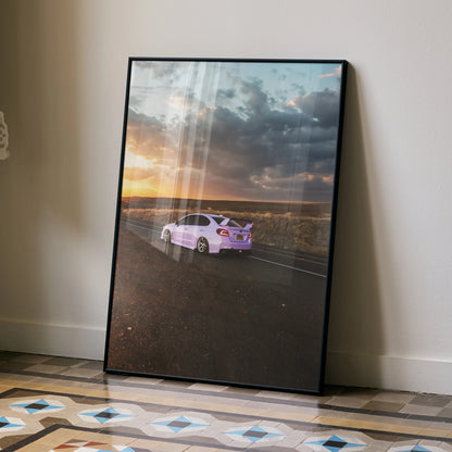 Subaru WRX parked on road under dramatic sunset sky poster wall art in black frame.