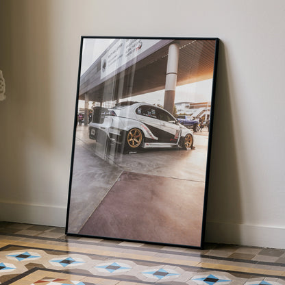 Mitsubishi Evo 10 poster with white car and bronze wheels against urban backdrop wall art.