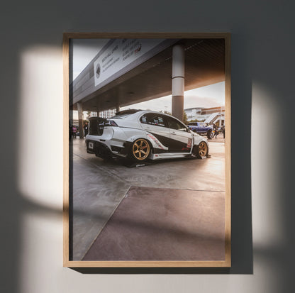 Mitsubishi Evo 10 poster with white car and gold rims under concrete structure, wall art in wood frame.