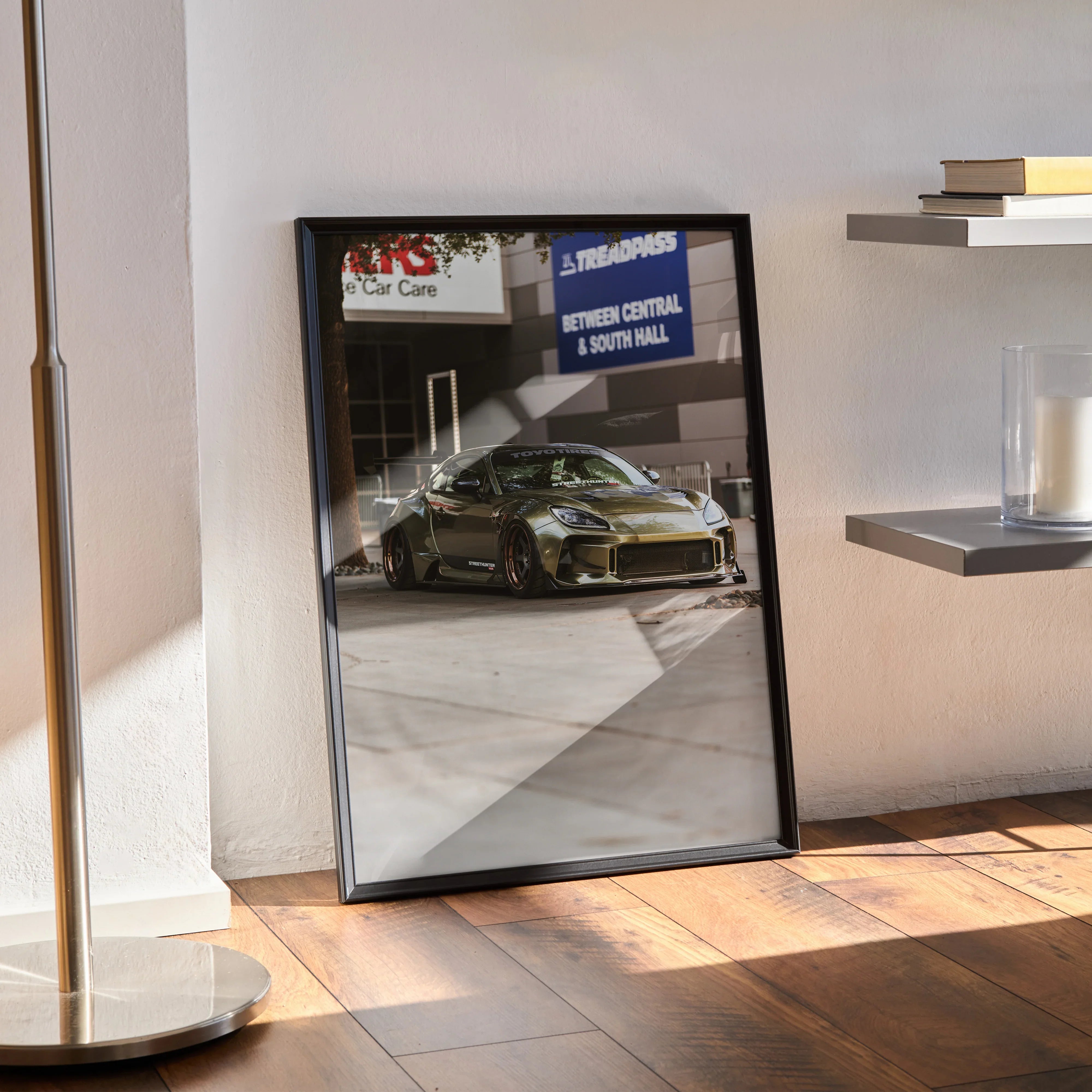 Subaru BRZ automotive art print poster in black frame leaning against wall on wooden floor wall art.