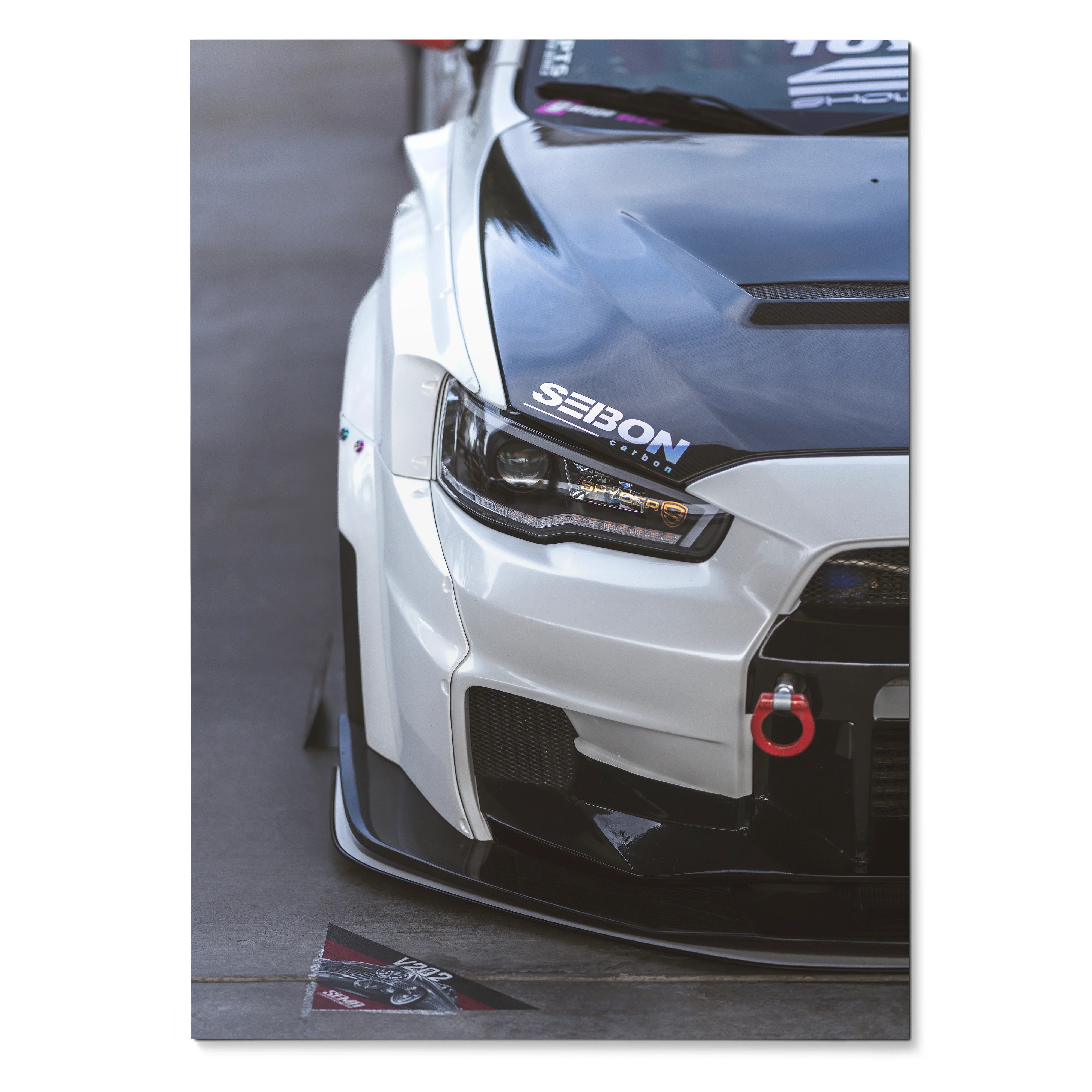 Mitsubishi Evo 10 front close-up poster with carbon hood and red tow hook wall art.