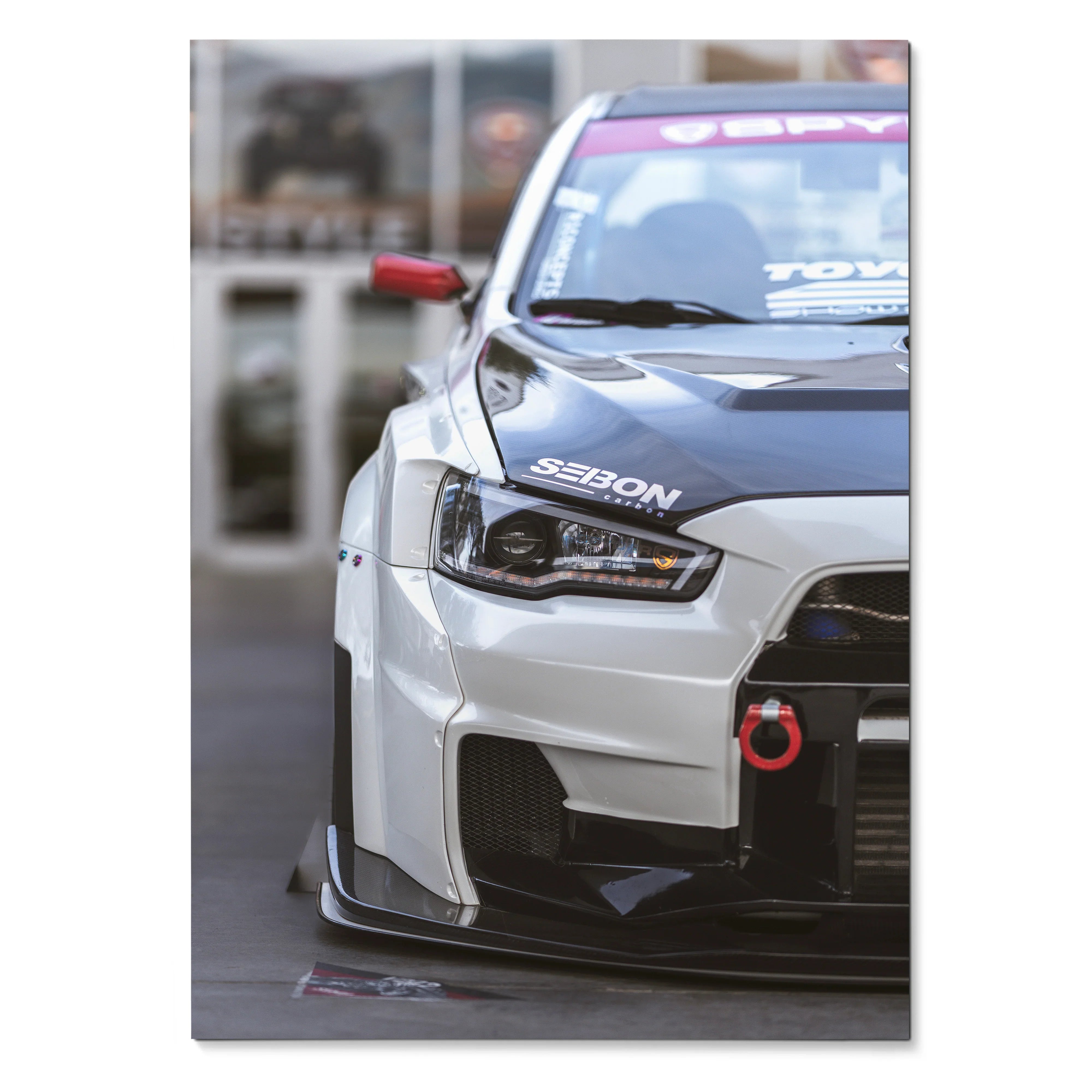 Close-up Mitsubishi Evo 10 front view poster with white body and black hood, automotive wall art.