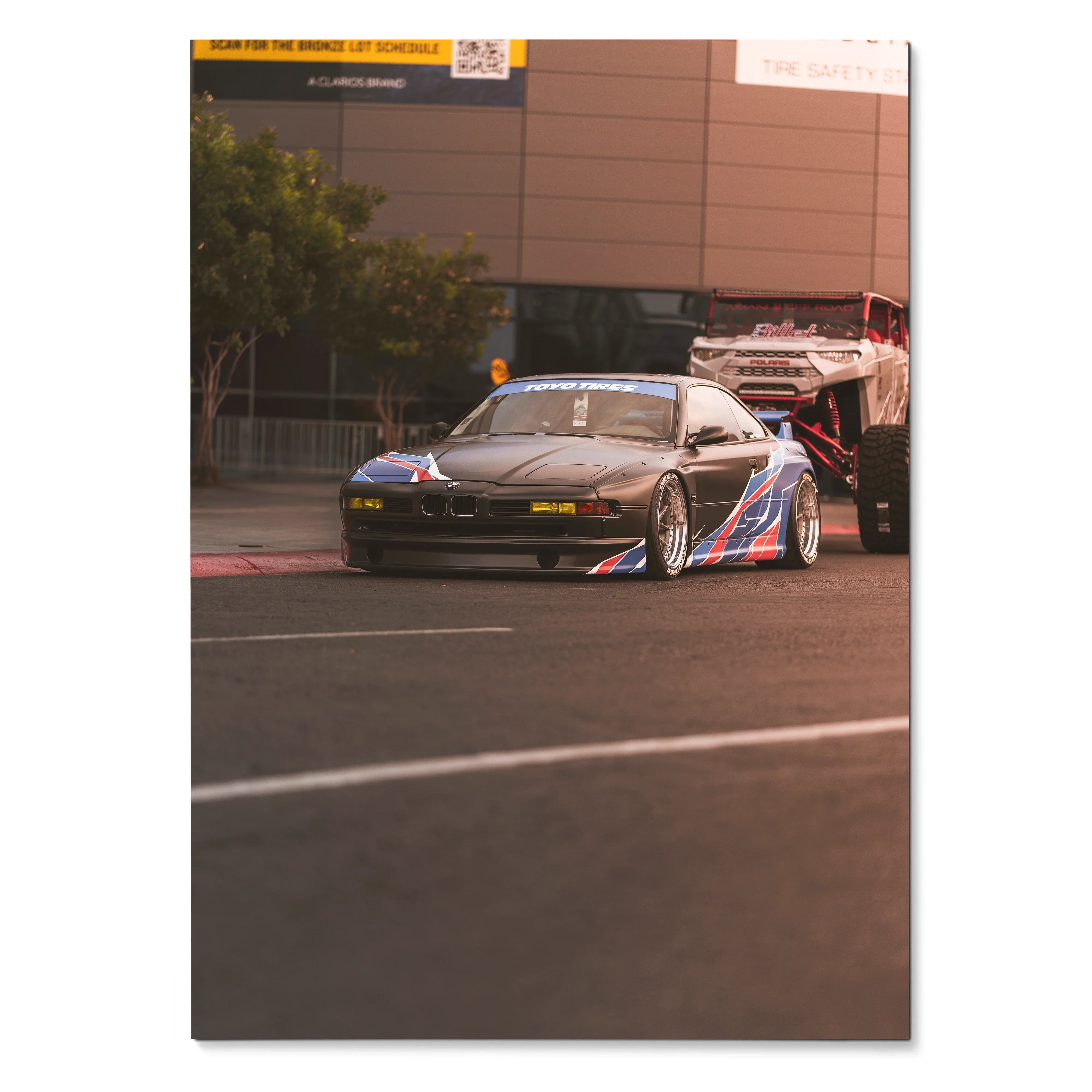 BMW E31 850ci race car with blue and red stripes on a racetrack poster wall art.