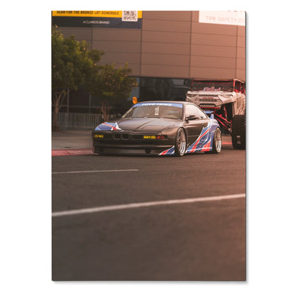 BMW E31 850ci race car with blue and red stripes on a racetrack poster wall art.