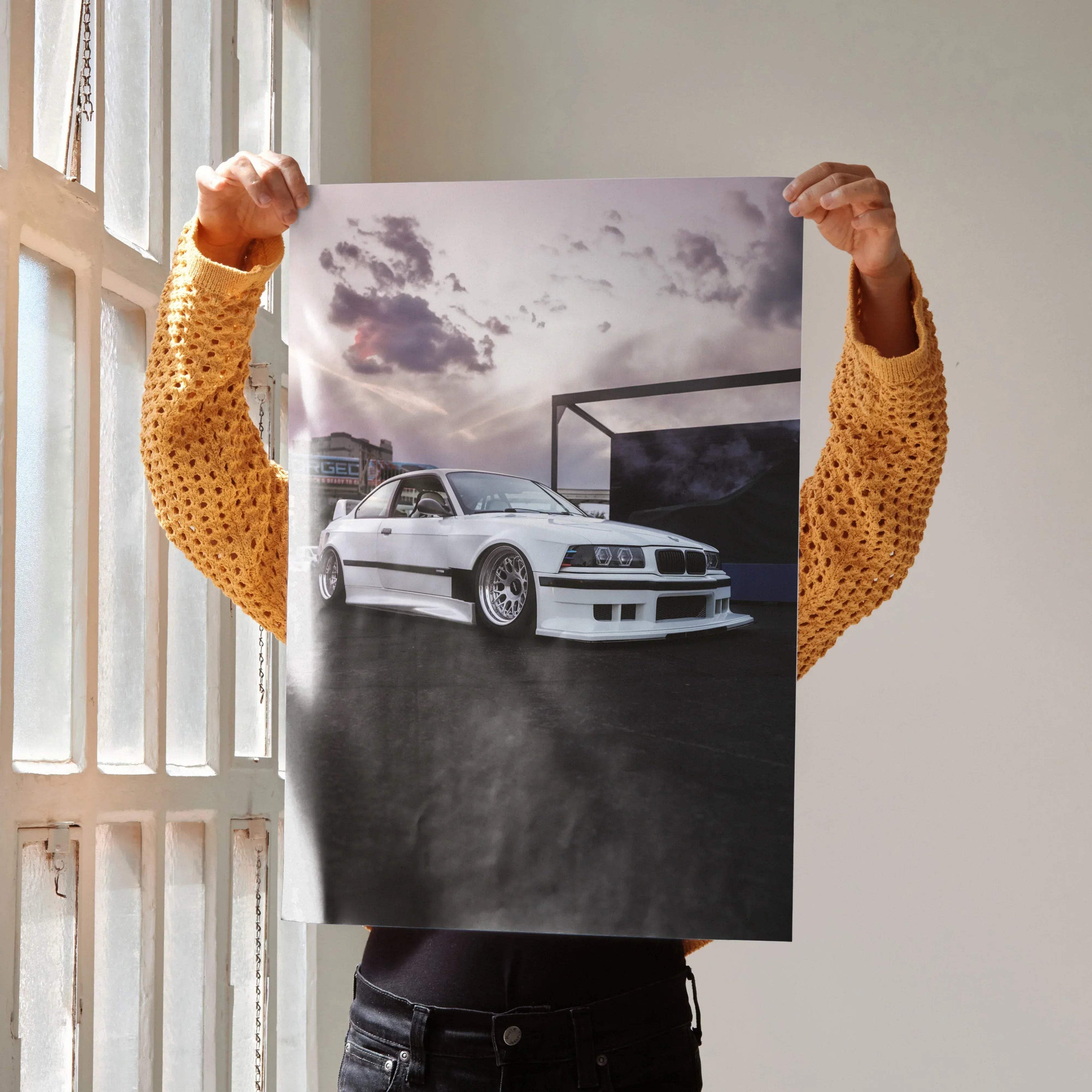 White BMW E36 M3 parked against cloudy sky on automotive poster wall art.