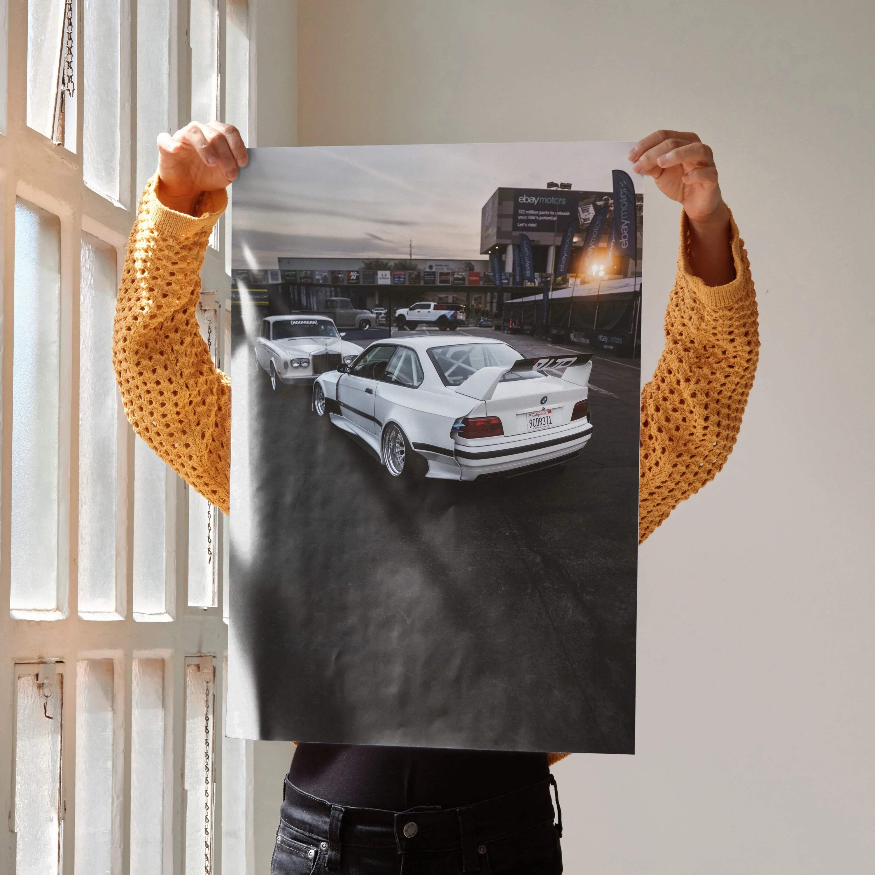 Poster of a white BMW E36 M3 on a racetrack under a cloudy sky, automotive wall art.