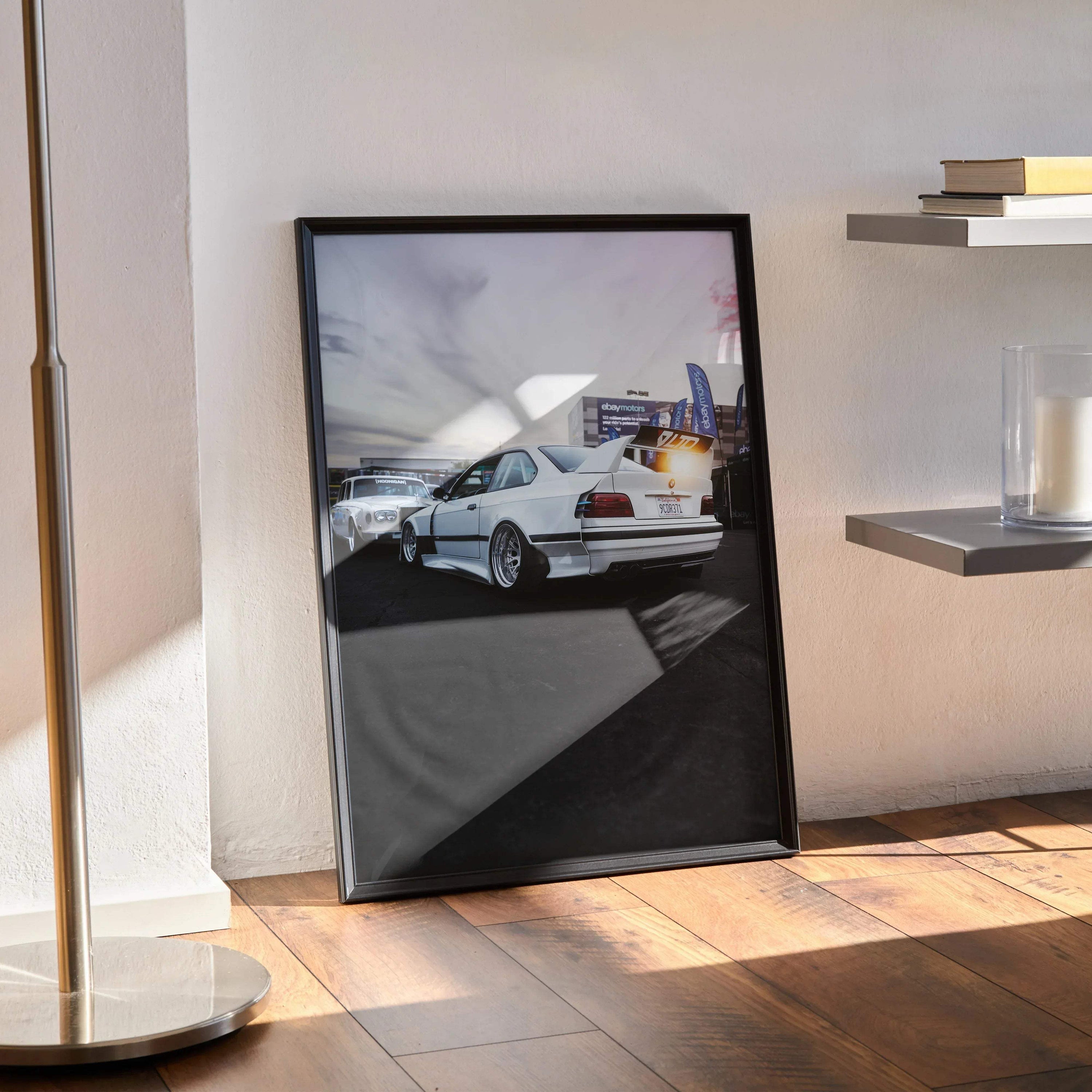 BMW E36 M3 widebody poster with high-resolution art, displayed leaning on floor wall art.