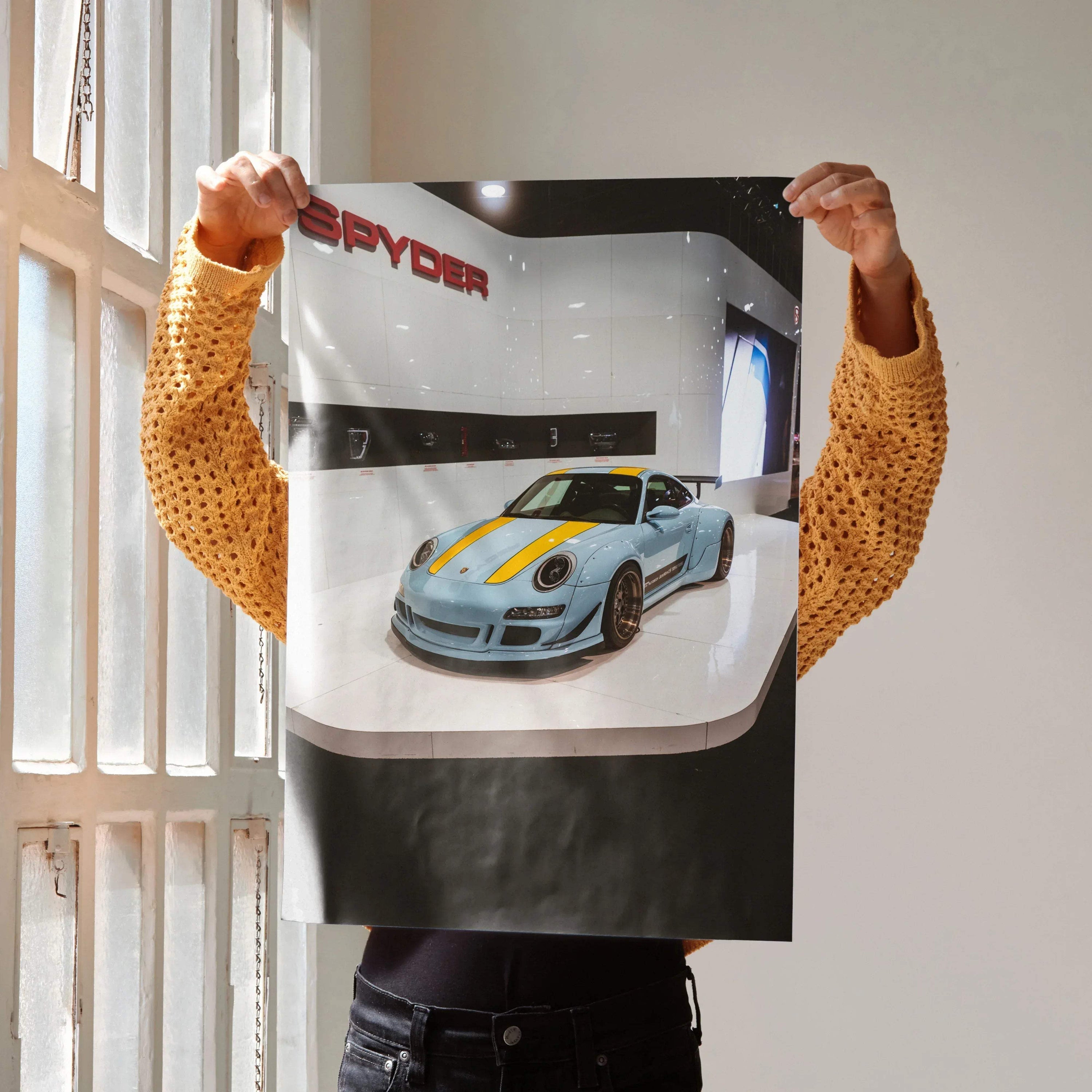 Porsche 911 Carrera 4 wall art poster with blue sports car and yellow racing stripes on gray background.