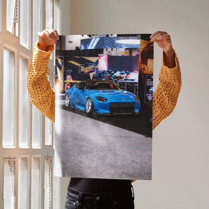 Nissan Z (RZ34) blue sports car poster held against window light, high-resolution wall art.