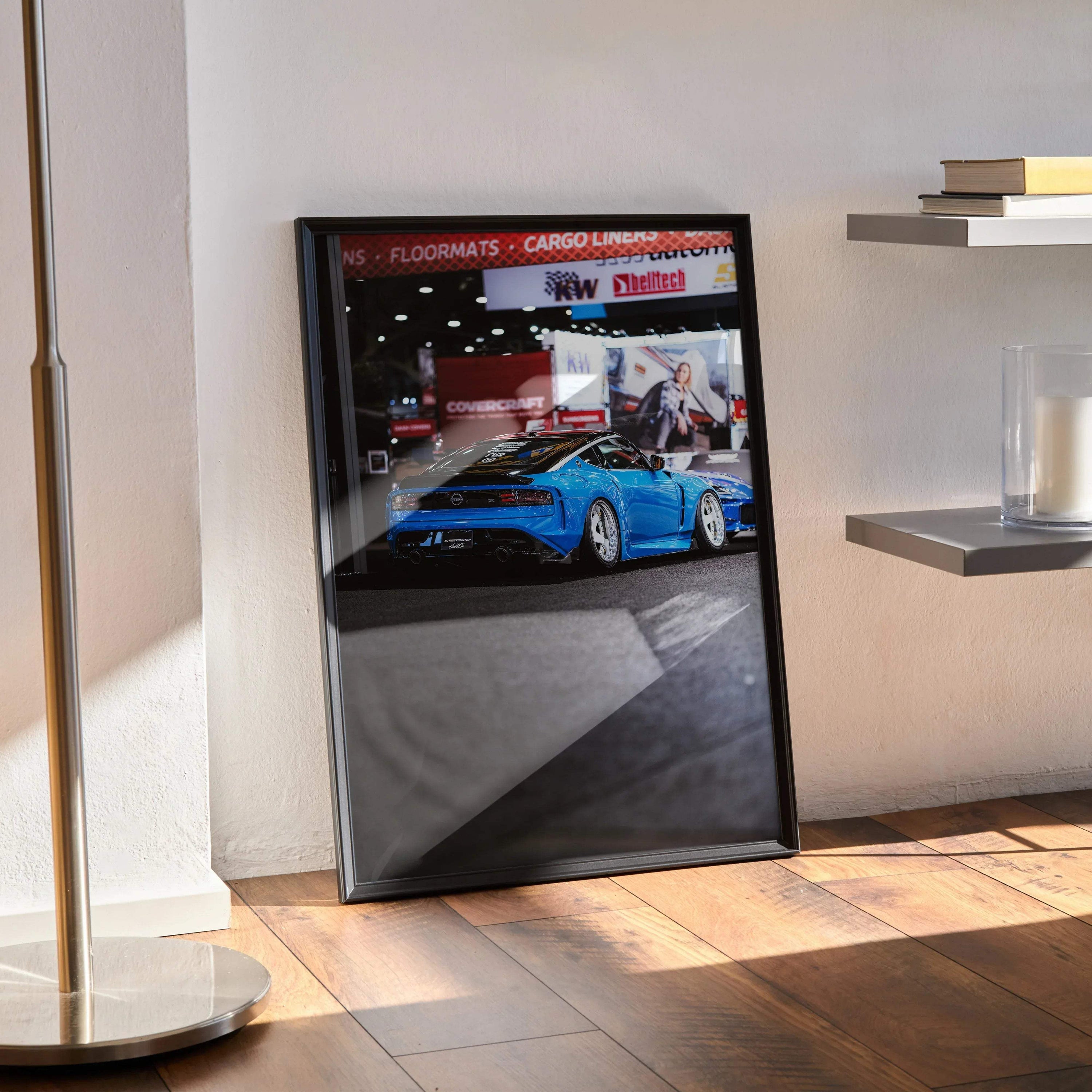 Framed Nissan Z (RZ34) poster wall art featuring vibrant blue sports car in showroom setting.