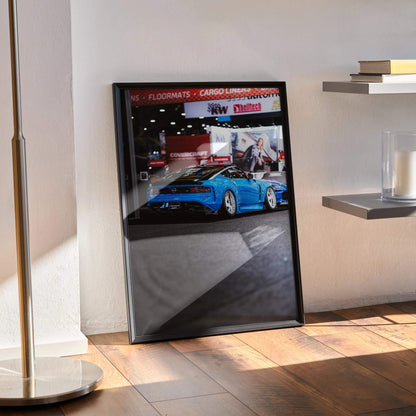 Framed Nissan Z (RZ34) poster wall art featuring vibrant blue sports car in showroom setting.