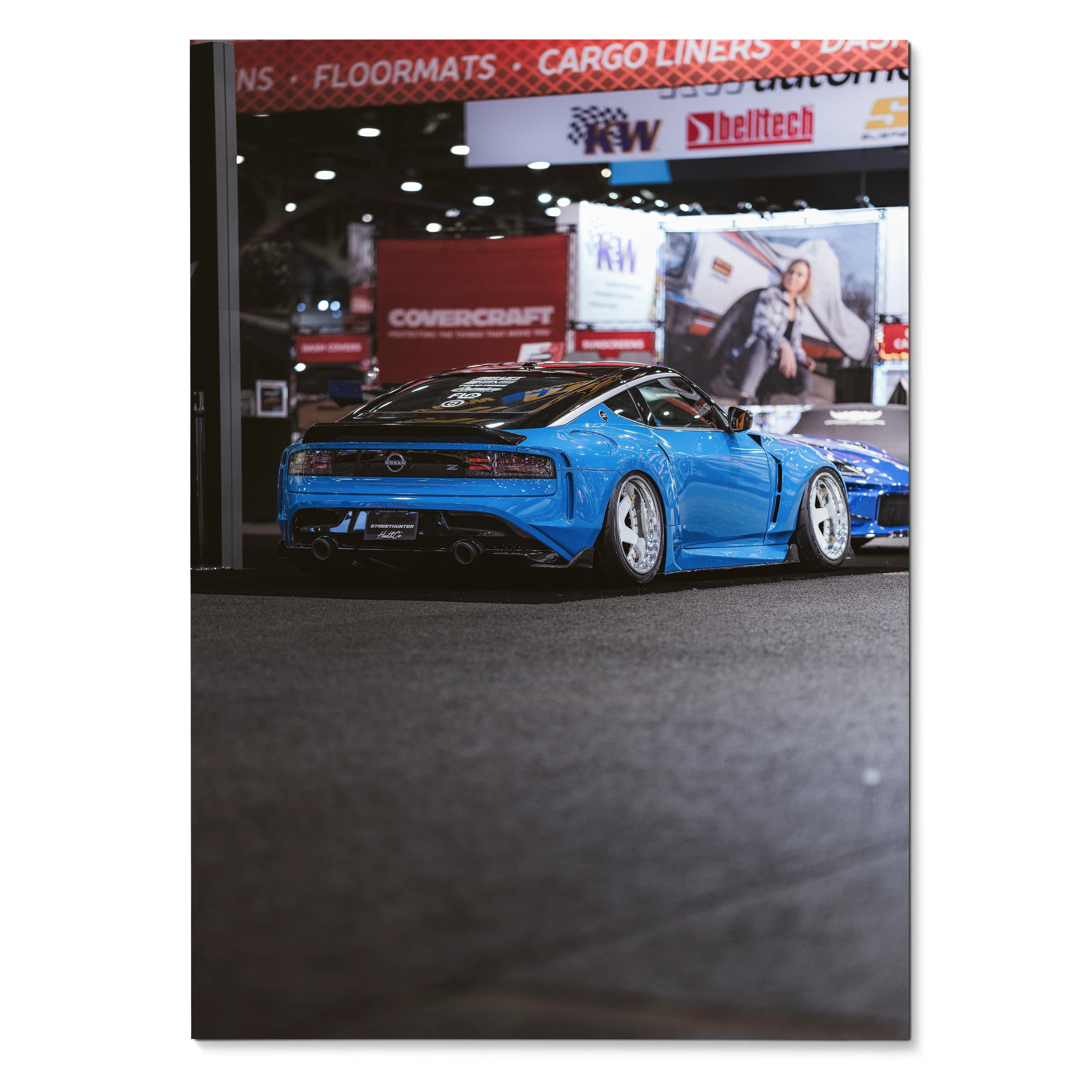 Nissan Z (RZ34) in bright blue displayed in indoor automotive show poster wall art.