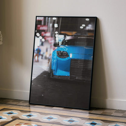 Nissan Z (RZ34) blue sports car close-up poster framed as automotive wall art leaning on floor.