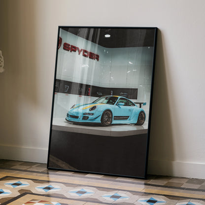 Blue Porsche 911 Carrera 4 poster wall art with sleek design leaning against wall.