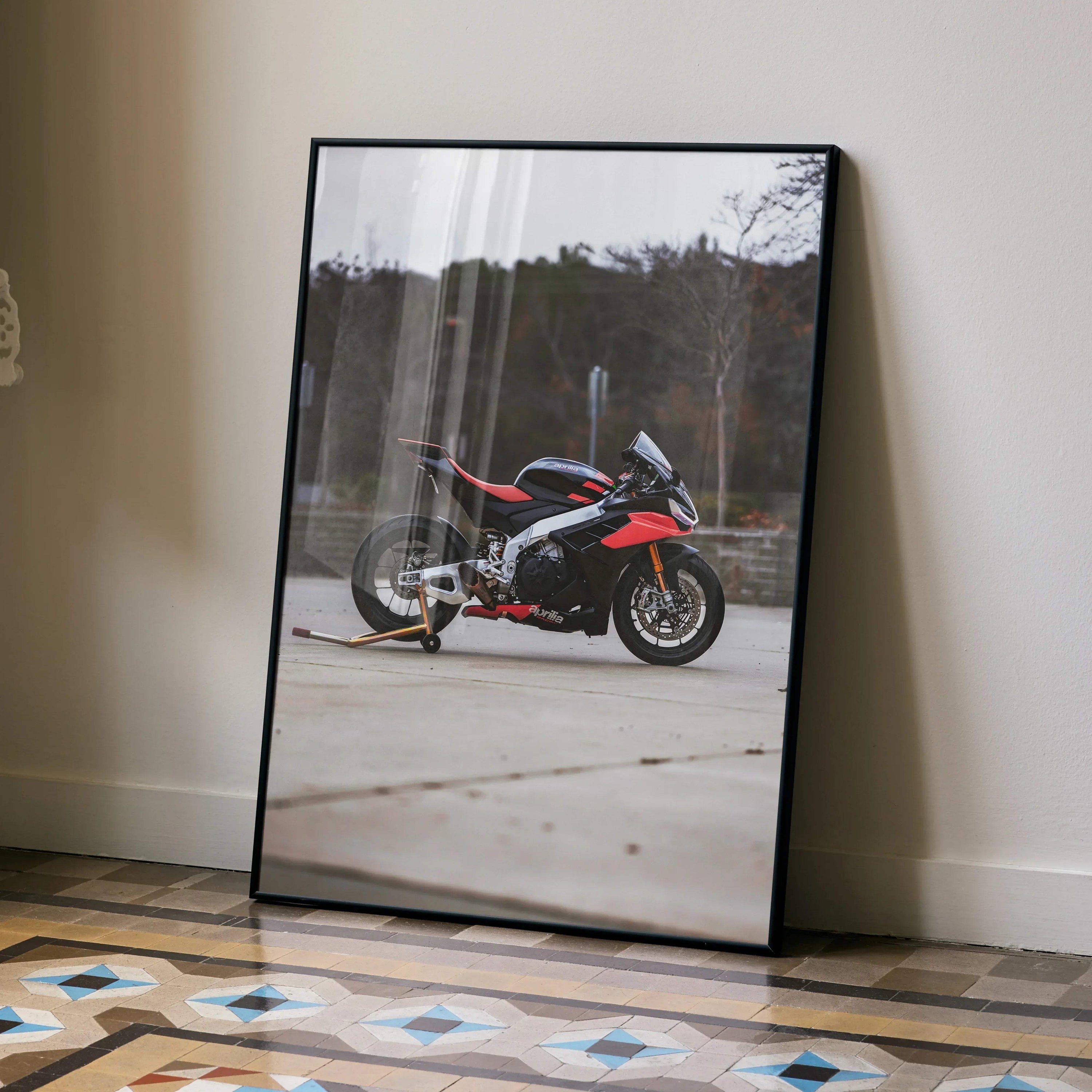 Aprilia RSV4 1100 Factory motorcycle poster leaning against wall, sleek black and red sportbike wall art.
