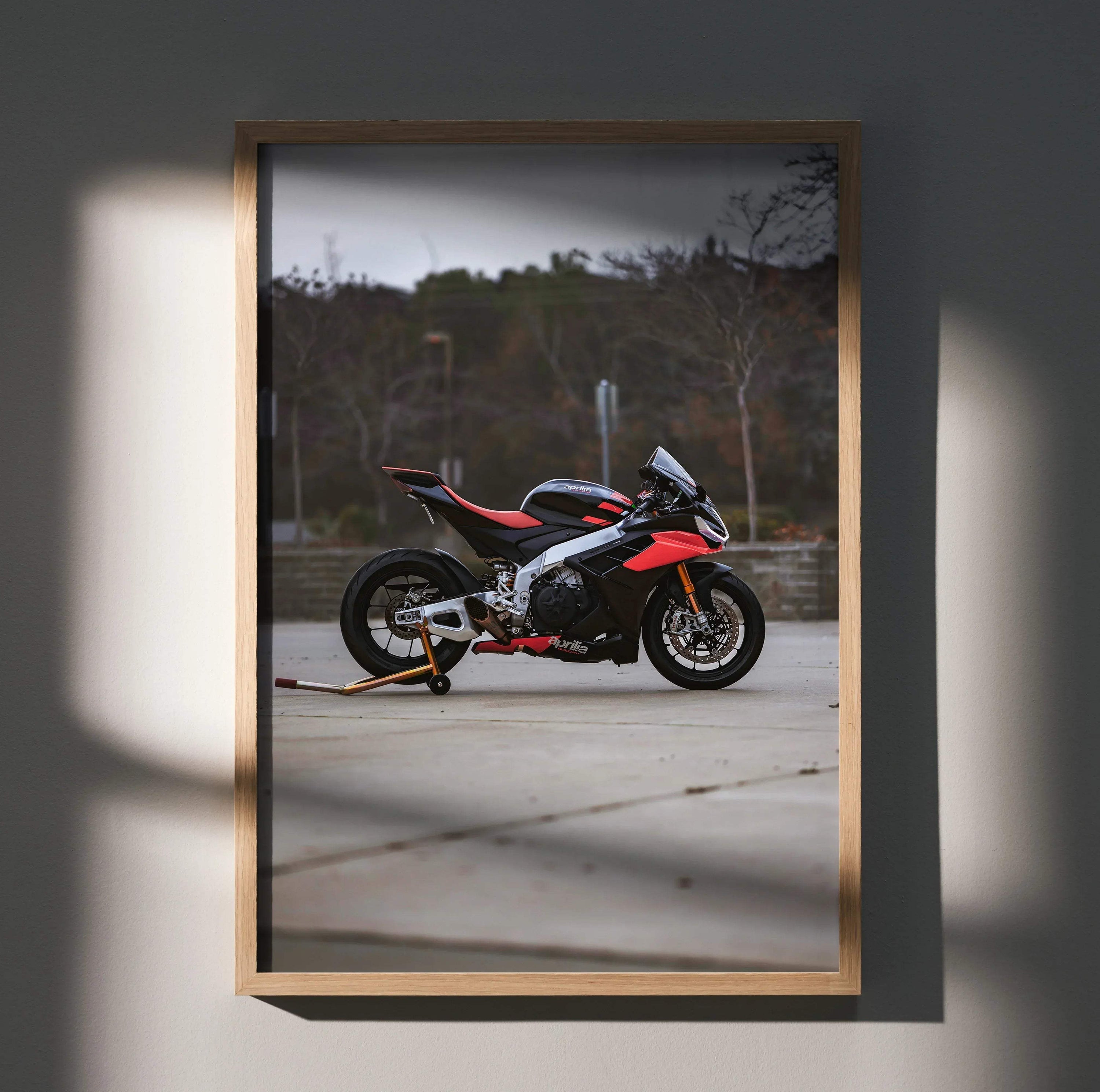 Aprilia RSV4 1100 Factory motorcycle poster wall art with black and red racing bike on stand.