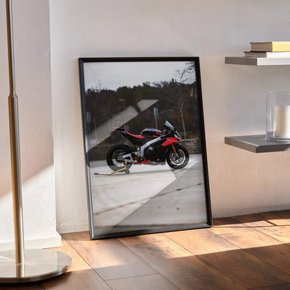 Aprilia RSV4 1100 Factory motorcycle poster in black frame leaning against wall, modern wall art.