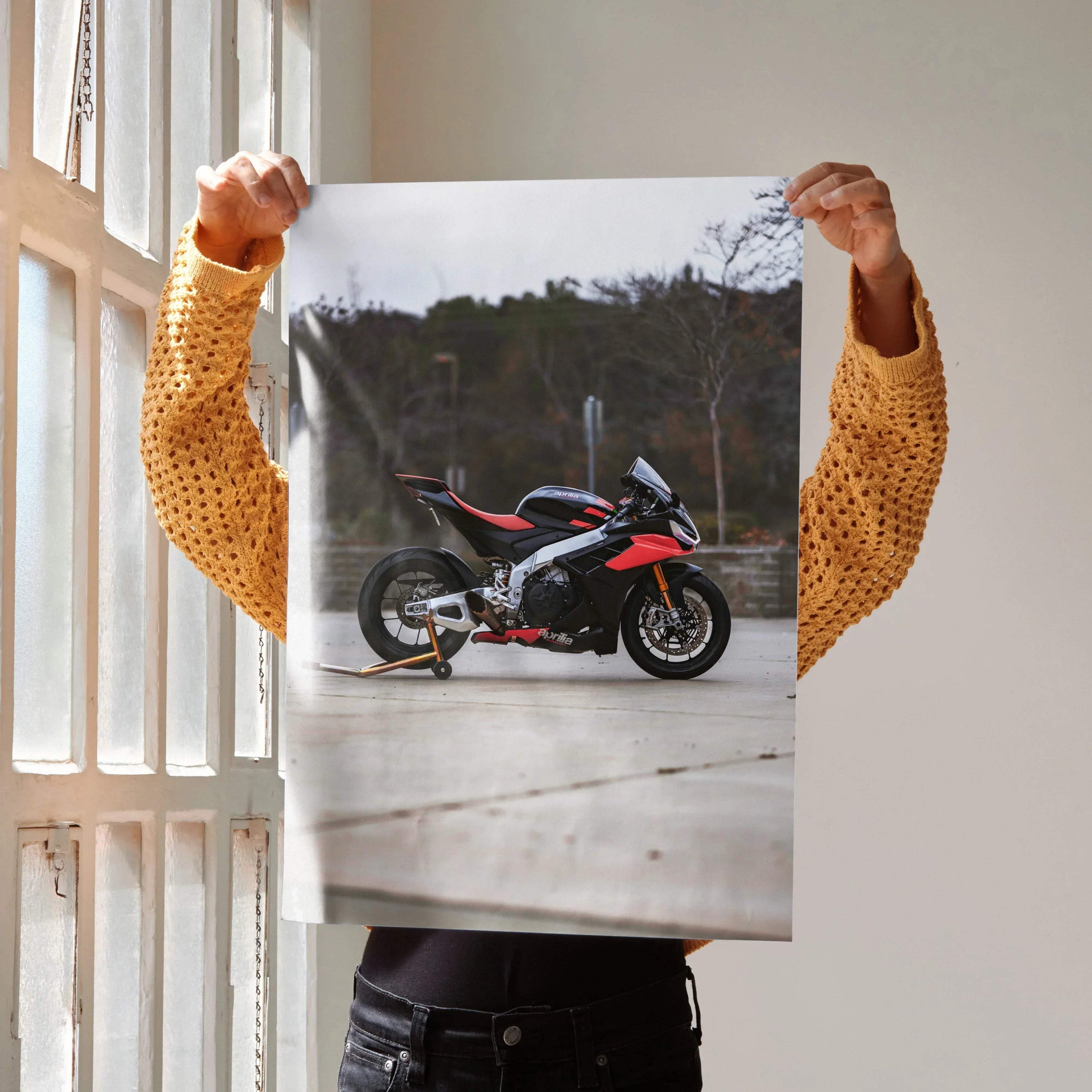 Poster wall art featuring a red and black Aprilia RSV4 1100 Factory motorcycle against an outdoor backdrop.